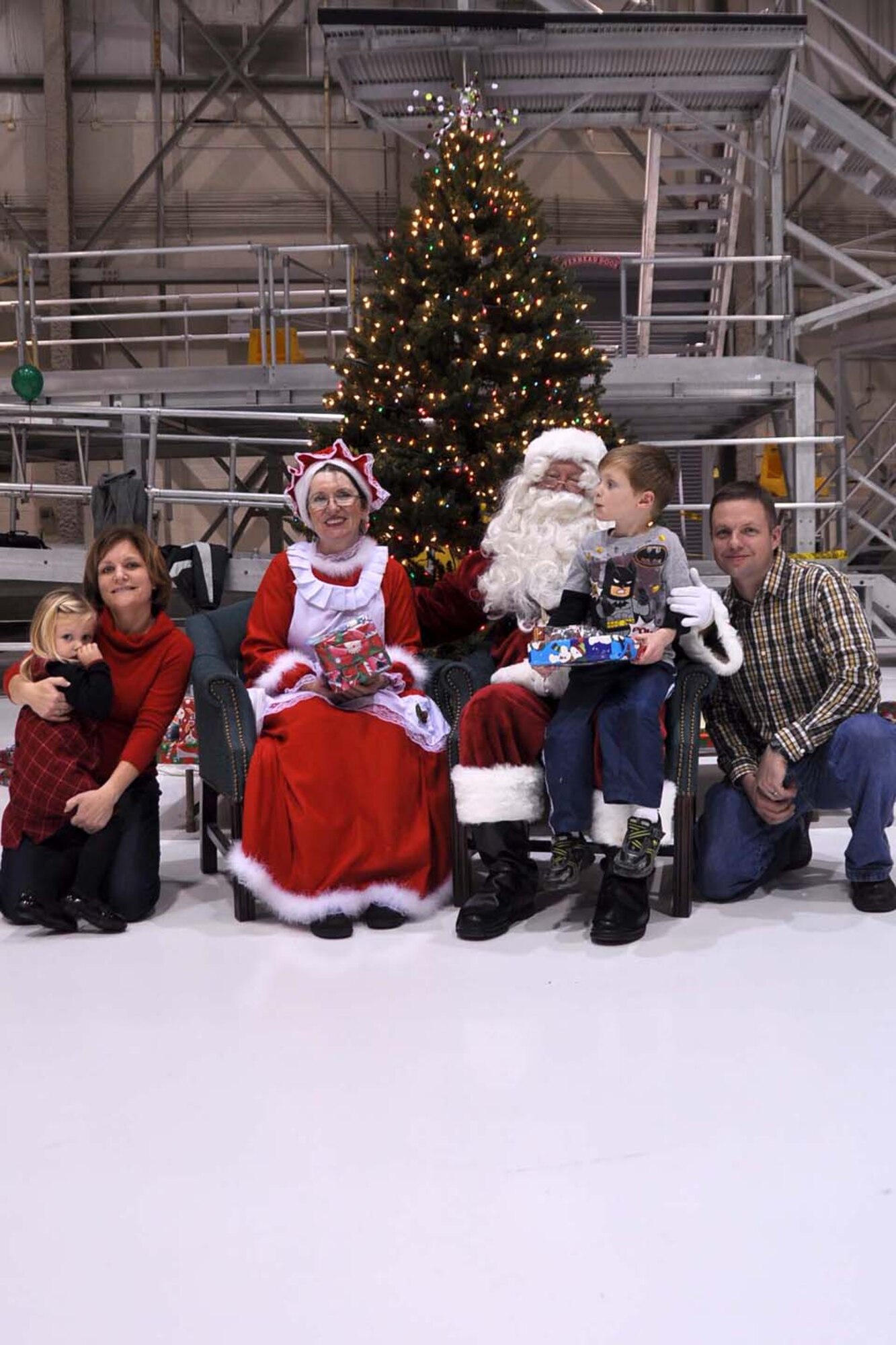 Family members and Airmen from the 128th Air Refueling Wing, Milwaukee, pose with Santa and Mrs. Claus during the annual holiday party on Saturday, Dec. 4, 2010.  From left are daughter Madelyn Mielcarek, mother Master Sgt. Jennifer Mielcarek, son Mason and father Capt. Tom Mielcarek.  The holiday party was hosted by the Airman and Family Readiness Program, and over 300 Airmen, military spouses and children attended.  U.S. Air Force photo by Staff Sgt. Jeremy Wilson / released