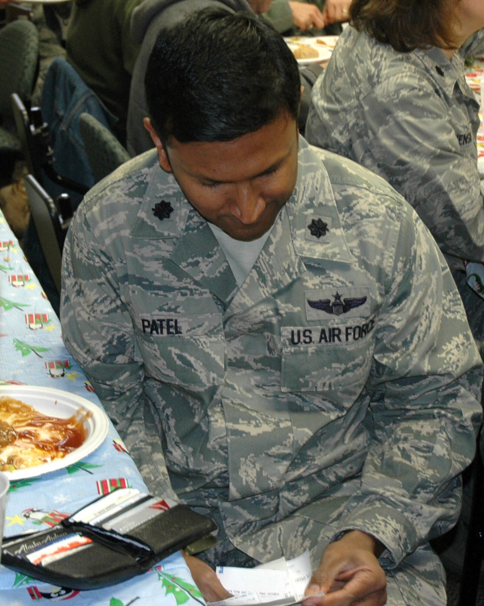 JOINT BASE LEWIS-MCCHORD, Wash.- Lt. Col. Nikhil Patel, 446th Force Support Squadron executive officer, hunts for a receipt for items valued under $5 from his wallet during the 446th FSS and wing staff scavenger hunt, Dec. 5 at the 446th FSS Airmen and Family Readiness Center. The scavenger hunt had Reservists scrounging around for not-so-common items like a military driver's license. (U.S. Air Force Photo/Staff Sgt. Nicole Celestine)