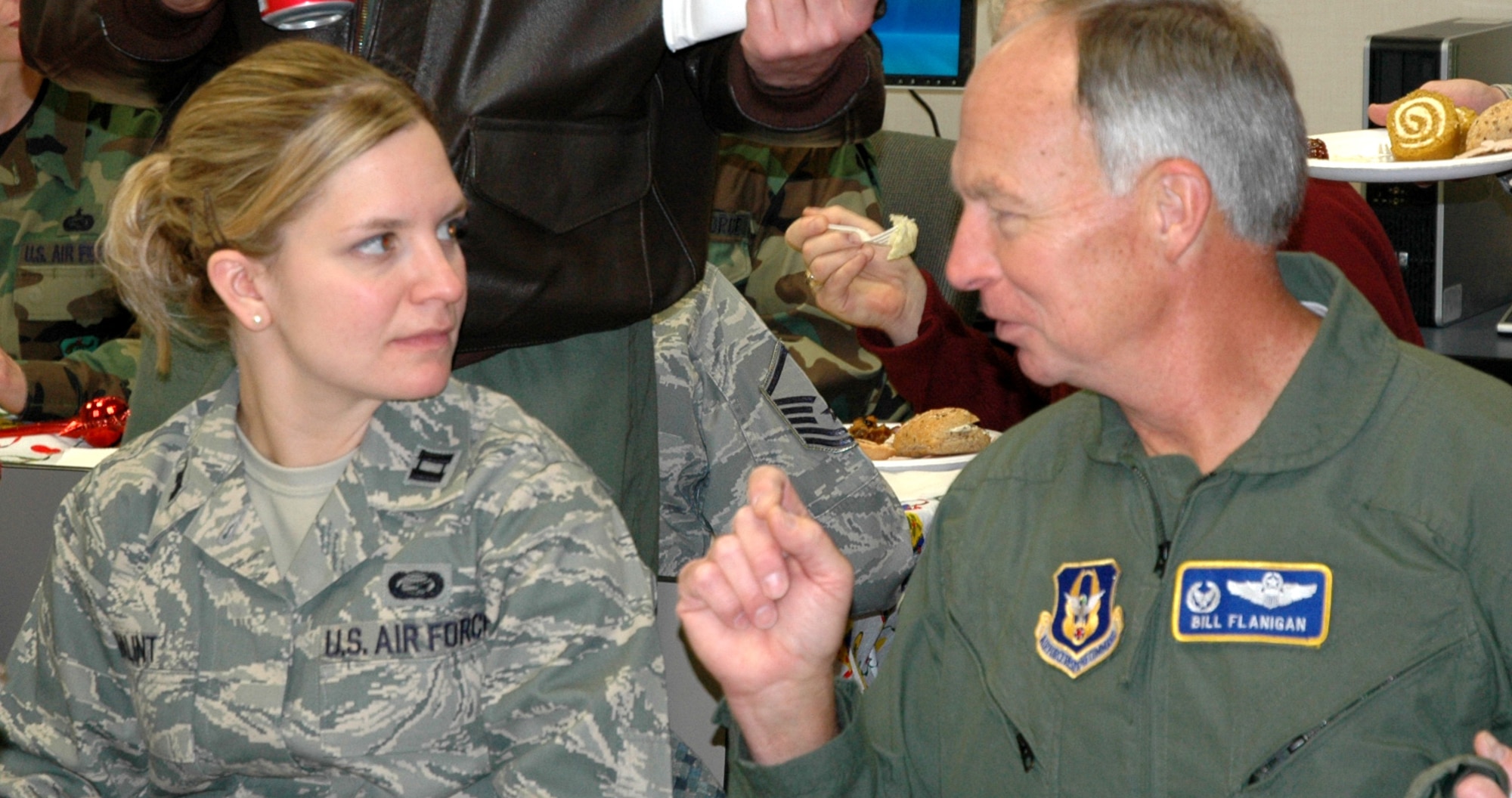 JOINT BASE LEWIS-MCCHORD, Wash.- Capt. Vanessa Balint, left, 446th Force Support Squadron military personnel flight commander and 446th Airlift Wing commander Bill Flanigan share a conversation during the 446th FSS and wing staff holiday brunch, Dec. 5 at the 446th FSS Airman and Family Readiness Center. The 446th AW held several unit holiday parties this weekend to herald in the holiday season. (U.S. Air Force Photo/Staff Sgt. Nicole Celestine)
