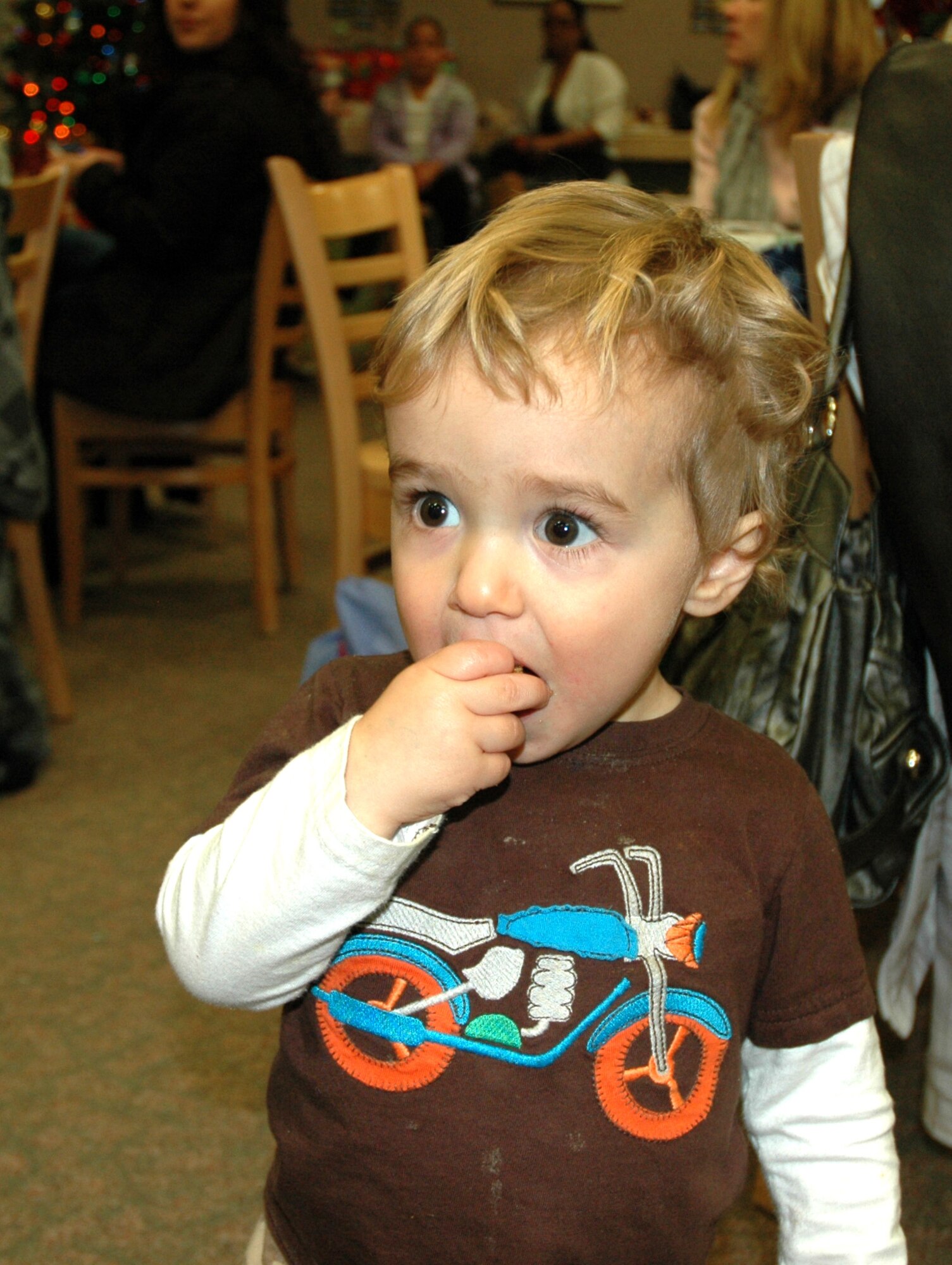 JOINT BASE LEWIS-MCCHORD, Wash.- Derek Haedt, son of Maj. Mike Haedt, 313th Airlift Squadron instructor pilot, enjoys a homemade  holiday cookie during the squadron's holiday party, Dec. 4 at Hangar 13. The 446th Airlift Wing held several squadron holiday parties this weekend to herald in the holiday season. (U.S. Air Force Photo/Staff Sgt. Nicole Celestine)