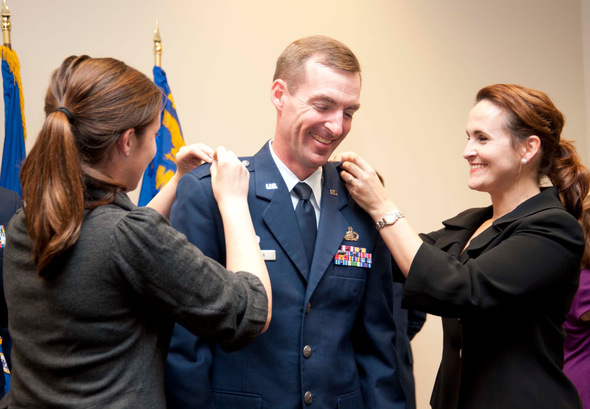 Lt. Col. Edward Segura holds steady as his wife, Misti (right), and daughter, Abigail, pin on his new lieutenant colonel rank at his assumption of command ceremony. The newly-promoted Lt. Col. Segura assumed command of the 403rd Aircraft Maintenance Squadron here during the December Unit Training Assembly. (Air Force photo by Tech. Sgt. Ryan Labadens)