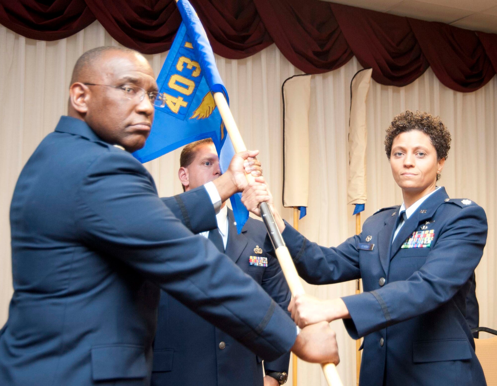 Lt. Col. Allyson Chauvin assumes command of the 403rd Force Support Squadron from Lt. Col. Marshall Irvin, 403rd Mission Support Group commander, in a ceremony held here during the December Unit Training Assembly. The 403rd Force Support Squadron combined the 403rd Mission Support Flight with the 403rd Services Flight in an Air Force-wide effort to prodive a more efficient, cost-effective way of handling customer service and personnel issues. (Air Force photo by Tech. Sgt. Ryan Labadens)