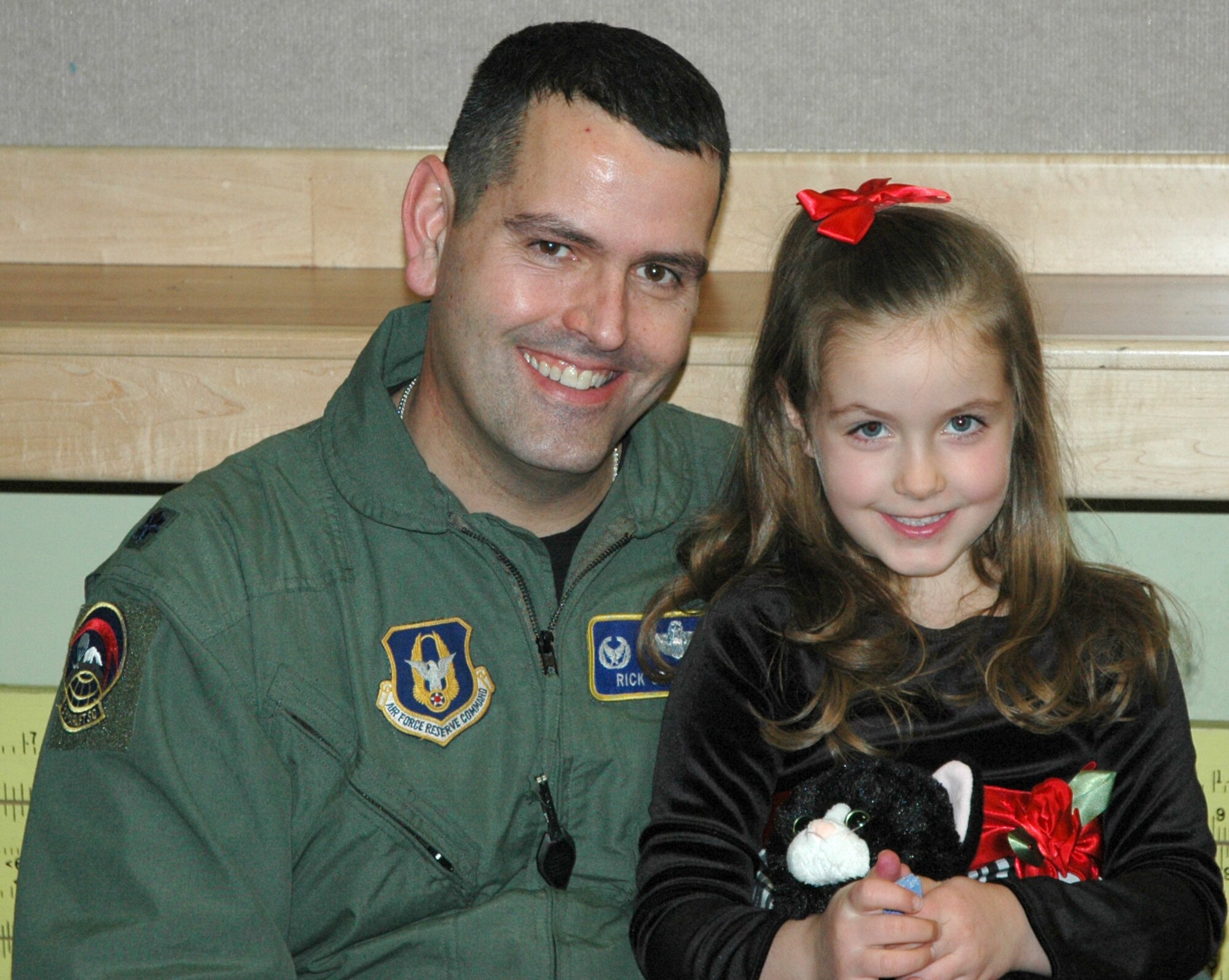 JOINT BASE LEWIS-MCCHORD, Wash. - Lt. Col. Rick Grayson, 313th Airlift Squadron commander, enjoys the holiday festivities with his 6-year-old daughter Annabella, during the squadron's holiday party, Dec. 4 in Hangar 13. Reservists across the 446th Airlift Wing attended unit holiday functions to herald in the holiday season.  (U.S. Air Force Photo/Staff Sgt. Nicole Celestine)