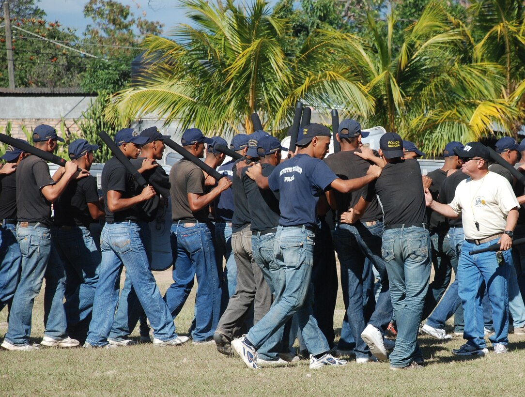 SOTO CANO AIR BASE, Honduras - Sgt. 1st Class Luis Rosado (right), Joint Task Force-Bravo Joint Security Forces, corrects cadets during training at the Honduras National Police Academy in La Paz, Comayagua, Dec. 2.  Members of the JTF-B JSF assisted training the cadets in self defense and riot control tactics. (U.S. Air Force photo by Army Pfc. Kelvin Rivera).