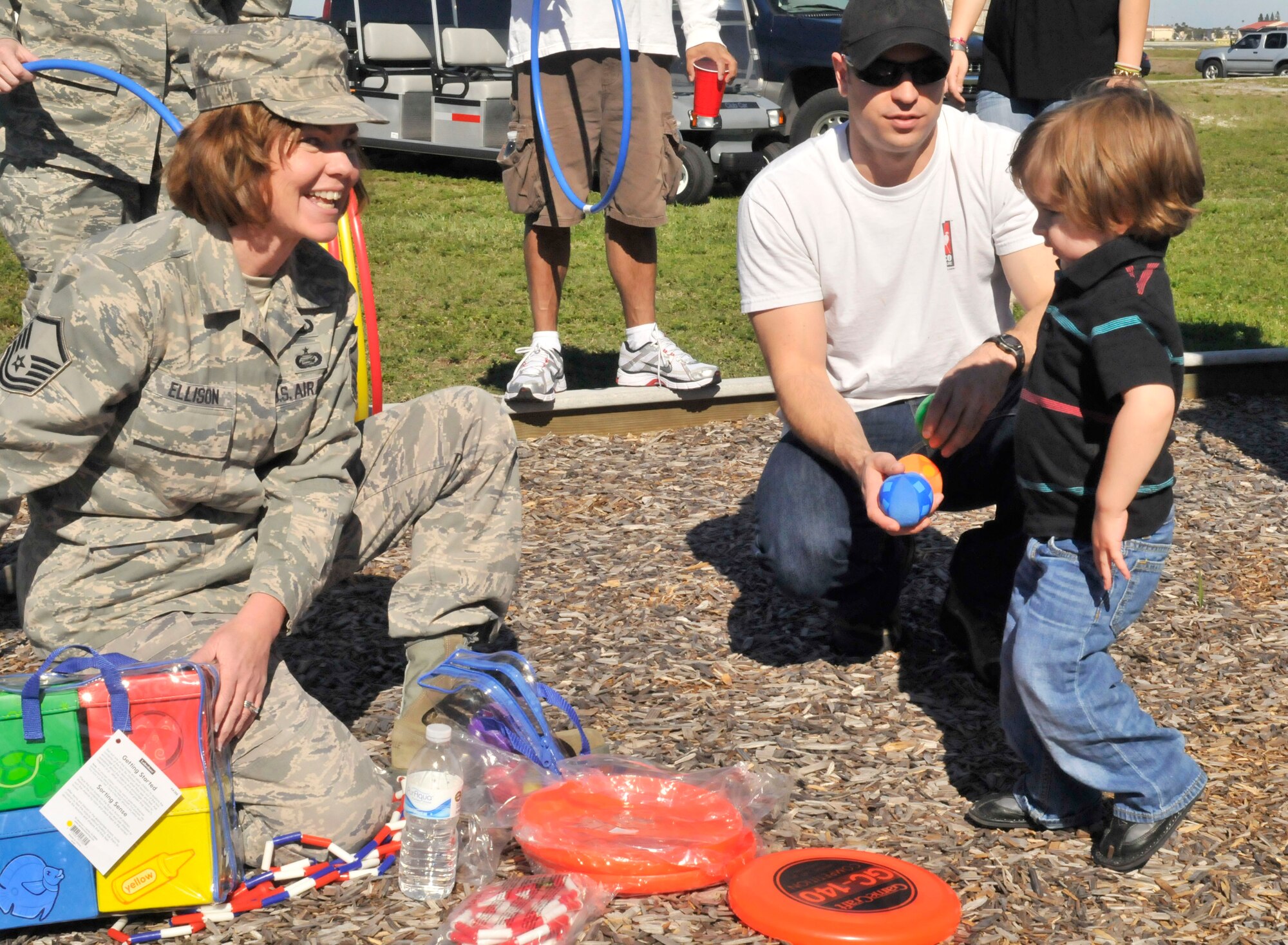 PATRICK AIR FORCE BASE, Fla. - MSgt Sherri Ellison of the 920th Mission Support Squadron hands out toys to a young child during the 920th Rescue Wing holiday party. The Italian-themed event was an opportunity for the 920th family to come together during the holiday season. (U.S. Air Force Photo/Capt. Ryan M. Liss)