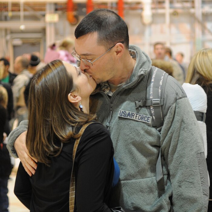 Tech. Sgt. Randon Beckstead kisses his wife after returning from a deployment to Southeast Asia, November 18, 2010, at the Utah Air National Guard Base in Salt Lake City. Sergeant Beckstead is a member of the 109th Air Control Squadron who was deployed for six months. (U.S. Air Force photo by Master Sgt. Gary J. Rihn)(RELEASED)