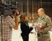 Capt. David Mulder is interviewed for a local TV station while he waits for his wife, Master Sgt. Cate Mulder, to arrive at the Utah Air National Guard Base in Salt Lake City, Utah, on November 18. Master Sgt. Mulder is a member of the 109th Air Control Squadron who spent six months deployed to Southeast Asia. (U.S. Air Force photo by Master Sgt. Gary J. Rihn)(RELEASED)