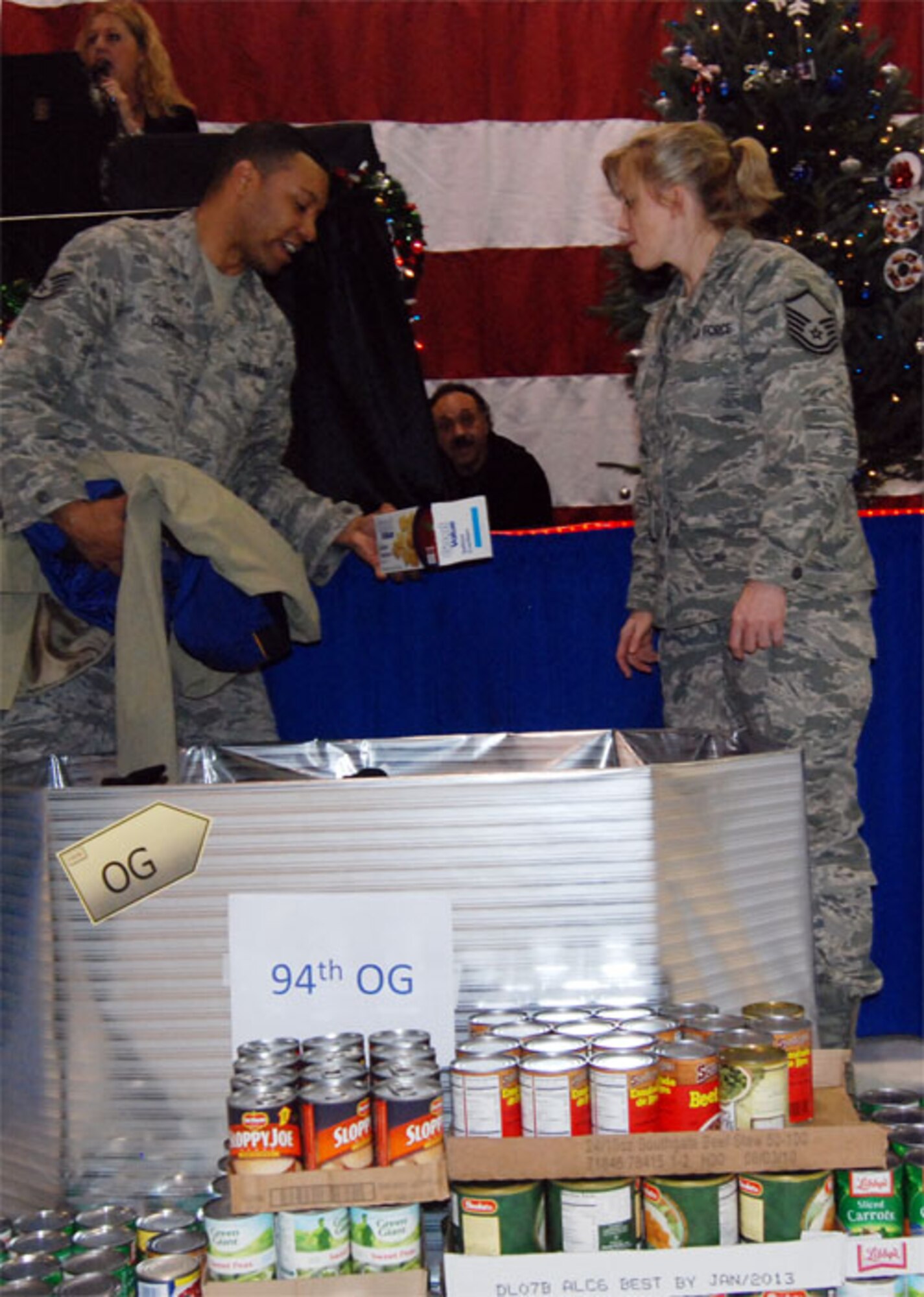 Citizen Airmen of the 94th Airlift Wing gathered at the Human Resources Development Council sponsored Holiday Party at Hangar 5 here Dec. 4. HRDC totaling contributions donated in the coat and food drive to determine the winner of the Annual Holiday Giving Back Trophy (U.S. Air Force photo/ Senior Airman Danielle Campbell)