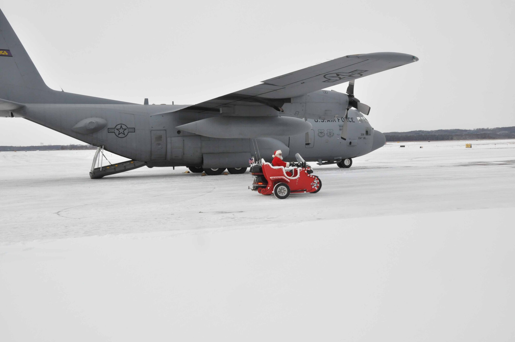 Santa at the "North Pole" next to a a 934th Airlift Wing C130 during Operation Santa Flight 2010, the 934th Airlift Wing along with volunteers from AT&T and the Army National Guard make it possible for people with special needs to get a trip to meet with Santa (Air Force Photo/Tech. Sgt. Bob Sommer)