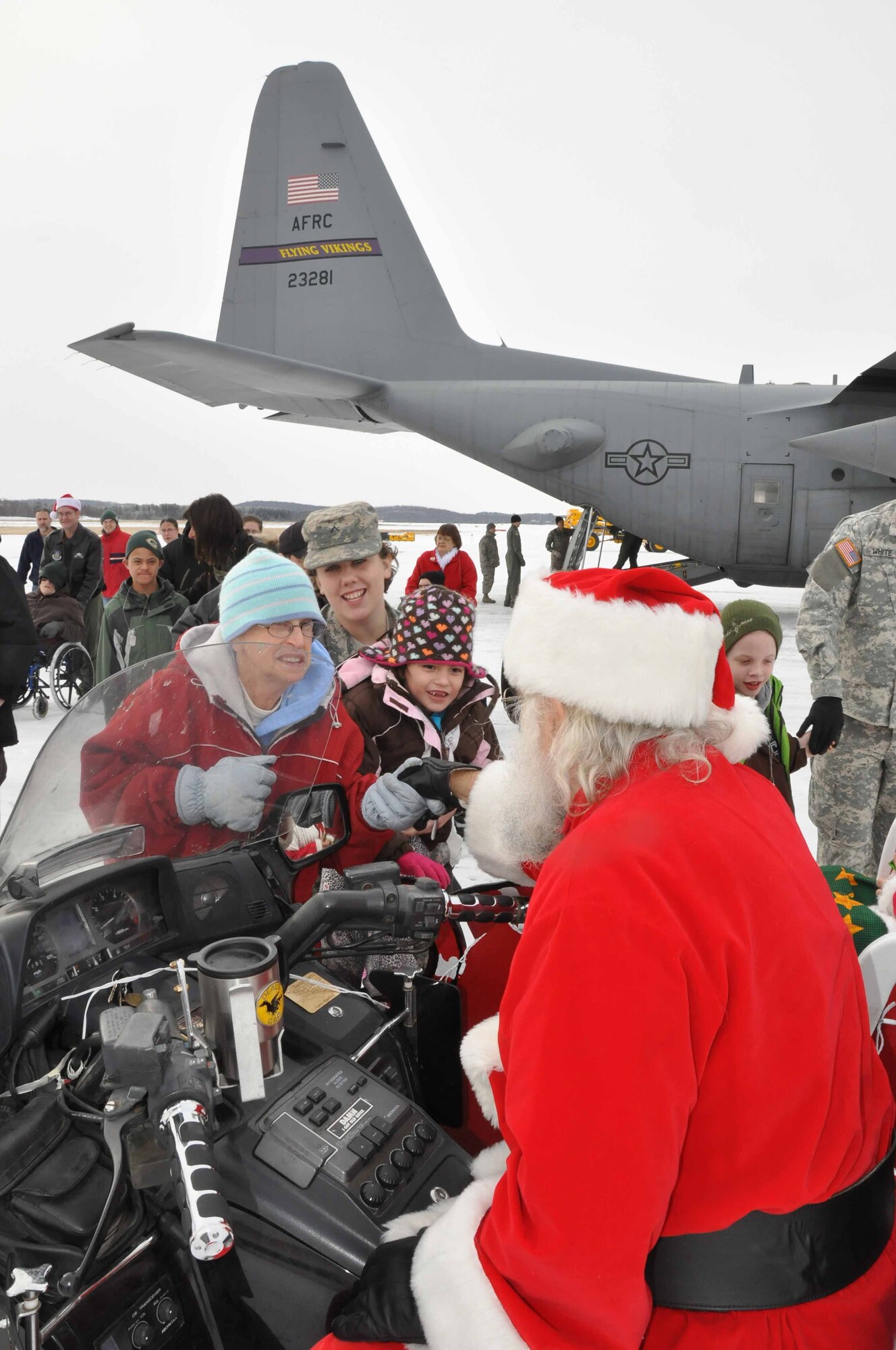 Special guests arrive at the "North Pole" on a 934th Airlift Wing C130 during Operation Santa Flight 2010, the 934th Airlift Wing along with volunteers from AT&T and the Army National Guard make it possible for people with special needs to get a trip to meet with Santa (Air Force Photo/Tech. Sgt. Bob Sommer)