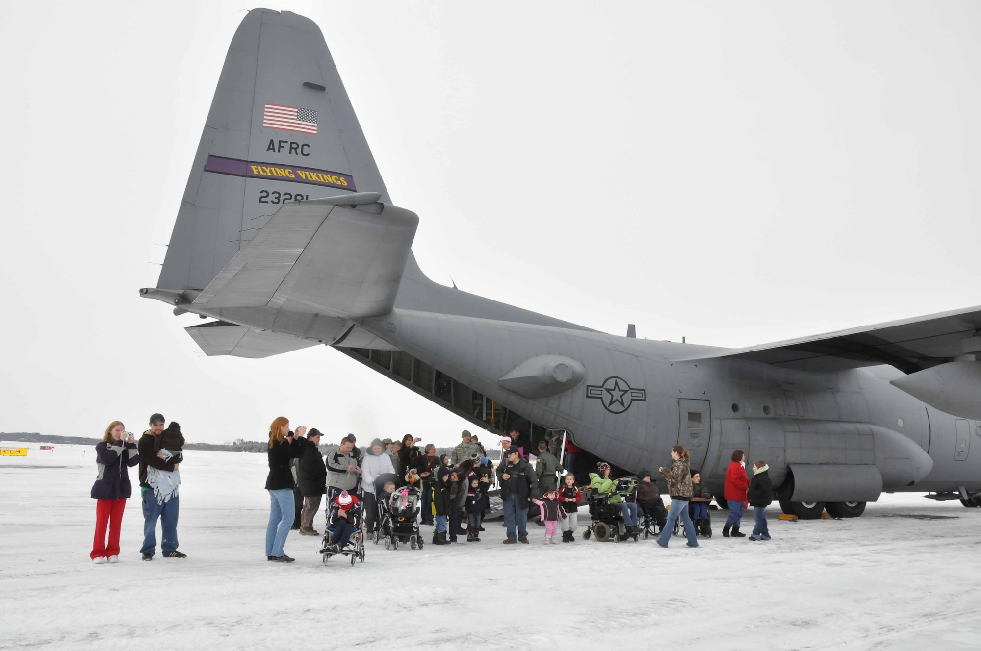 Special guests arrive at the "North Pole" on a 934th Airlift Wing C130 during Operation Santa Flight 2010, the 934th Airlift Wing along with volunteers from AT&T and the Army National Guard make it possible for people with special needs to get a trip to meet with Santa (Air Force Photo/Tech. Sgt. Bob Sommer)