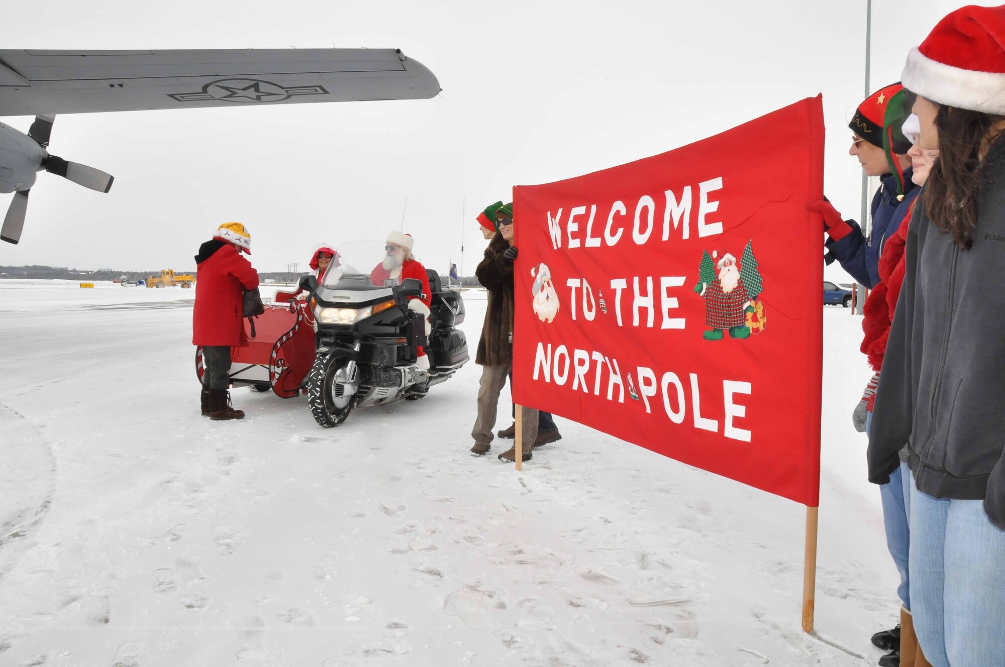 Special guests arrive at the "North Pole" on a 934th Airlift Wing C130 during Operation Santa Flight 2010, the 934th Airlift Wing along with volunteers from AT&T and the Army National Guard make it possible for people with special needs to get a trip to meet with Santa (Air Force Photo/Tech. Sgt. Bob Sommer)