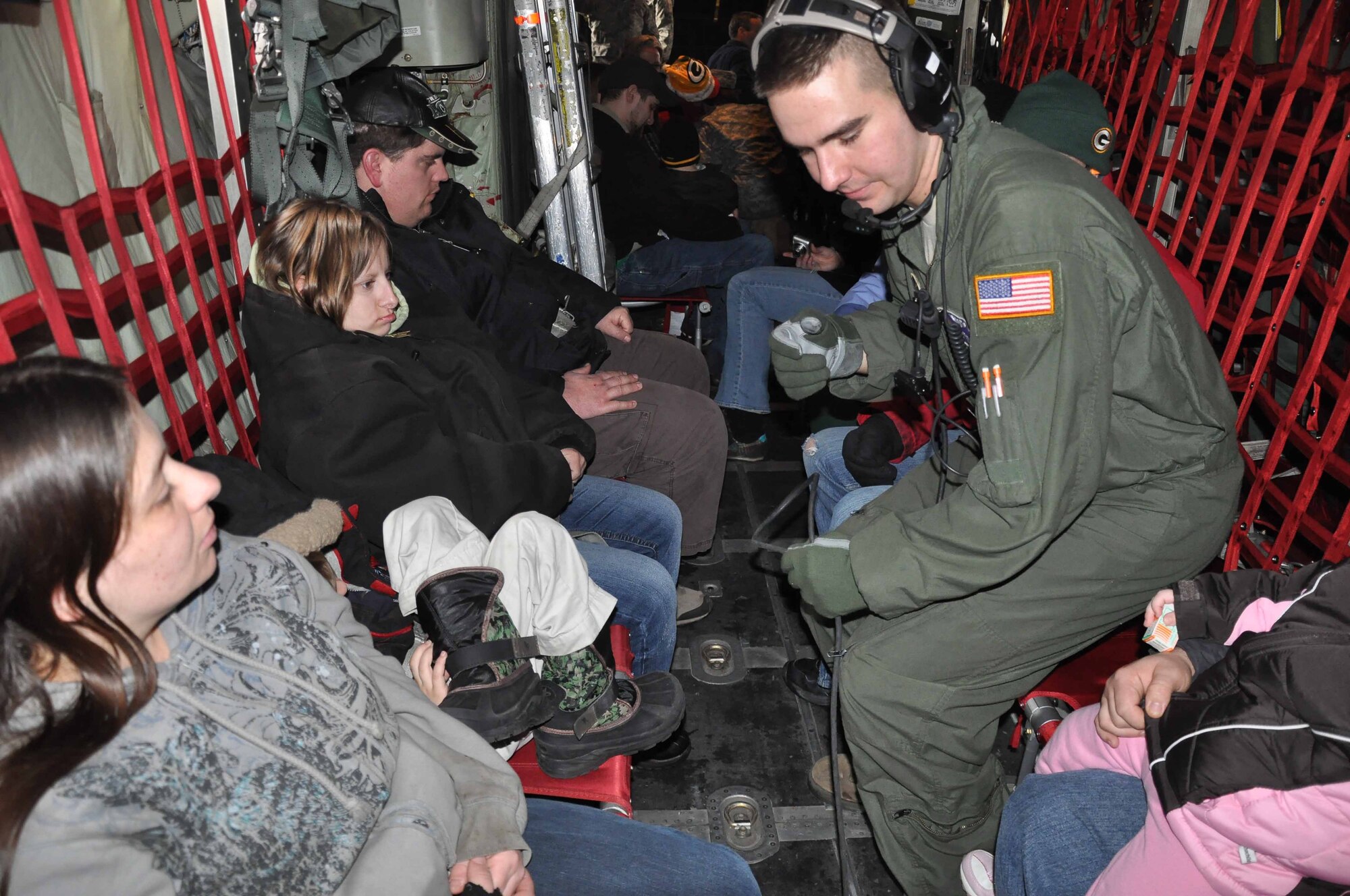 SRA Erik Pfarr talks with special guests during Operation Santa Flight 2010, the 934th Airlift Wing along with volunteers from AT&T and the Army National Guard make it possible for people with special needs to get a trip to meet with Santa (Air Force Photo/Tech. Sgt. Bob Sommer)