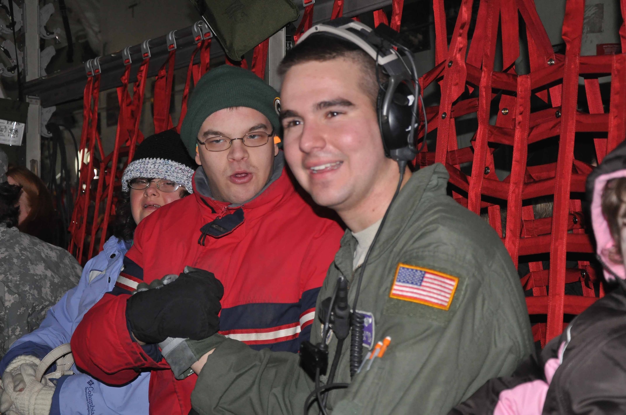 SRA Erik Pfarr talks with special guests during Operation Santa Flight 2010, the 934th Airlift Wing along with volunteers from AT&T and the Army National Guard make it possible for people with special needs to get a trip to meet with Santa (Air Force Photo/Tech. Sgt. Bob Sommer)