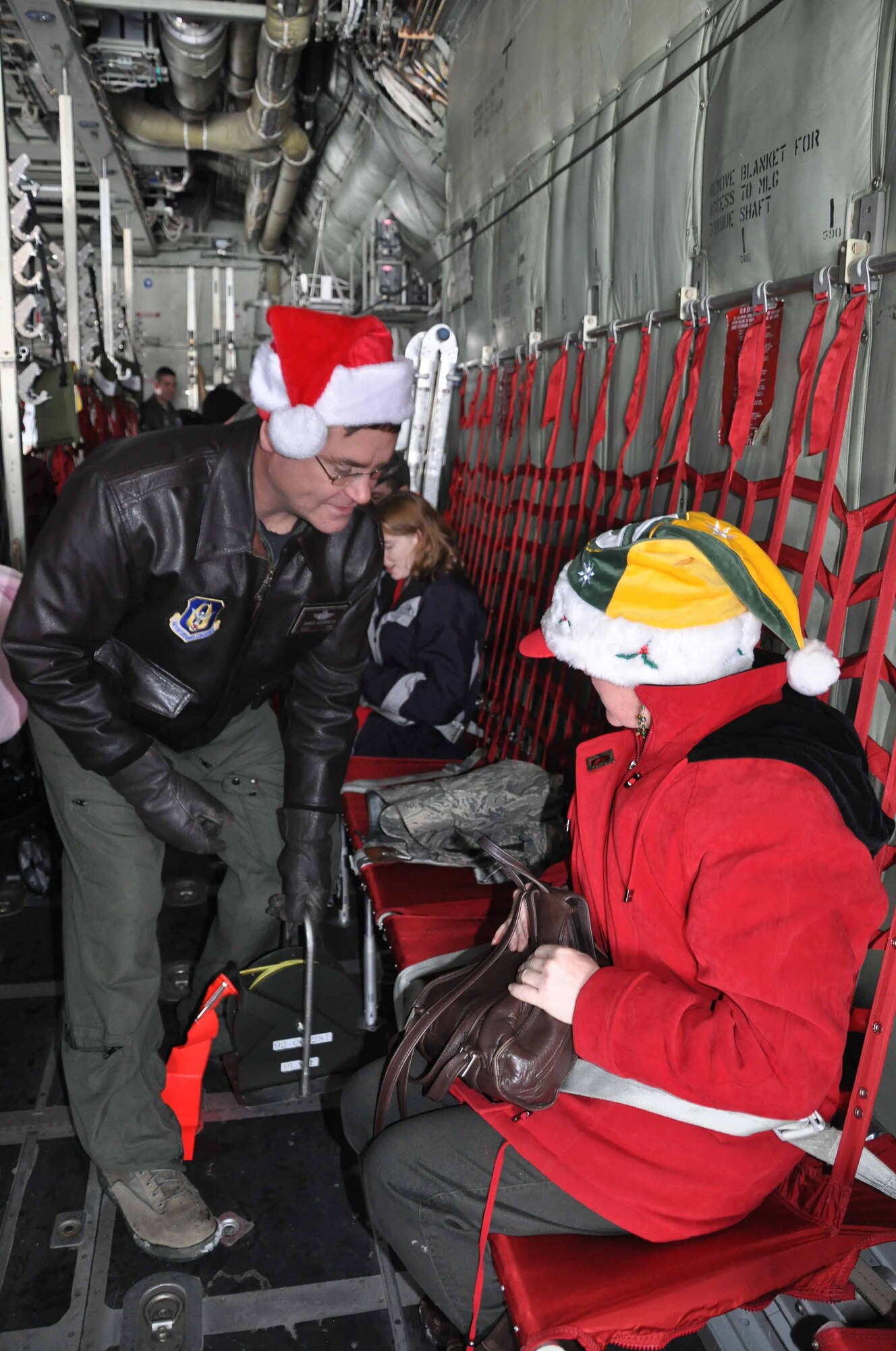 Msgt. James Courneya Gives a saftey briefing to special guests during Operation Santa Flight 2010, the 934th Airlift Wing along with volunteers from AT&T and the Army National Guard make it possible for people with special needs to get a trip to meet with Santa (Air Force Photo/Tech. Sgt. Bob Sommer)