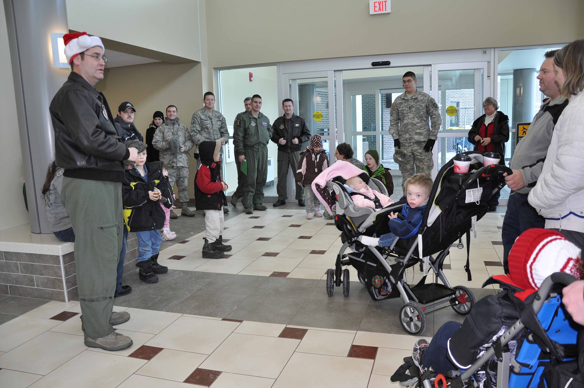 Msgt. James Courneya Gives a saftey briefing to special guests during Operation Santa Flight 2010, the 934th Airlift Wing along with volunteers from AT&T and the Army National Guard make it possible for people with special needs to get a trip to meet with Santa (Air Force Photo/Tech. Sgt. Bob Sommer)