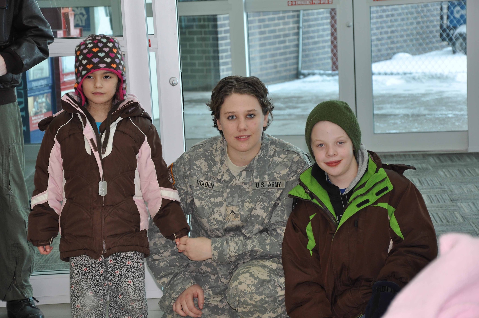 Army National Guard, Private Ashley Volden Hangs out with special guests during Operation Santa Flight 2010, the 934th Airlift Wing along with volunteers from AT&T and the Army National Guard make it possible for people with special needs to get a trip to meet with Santa (Air Force Photo/Tech. Sgt. Bob Sommer)