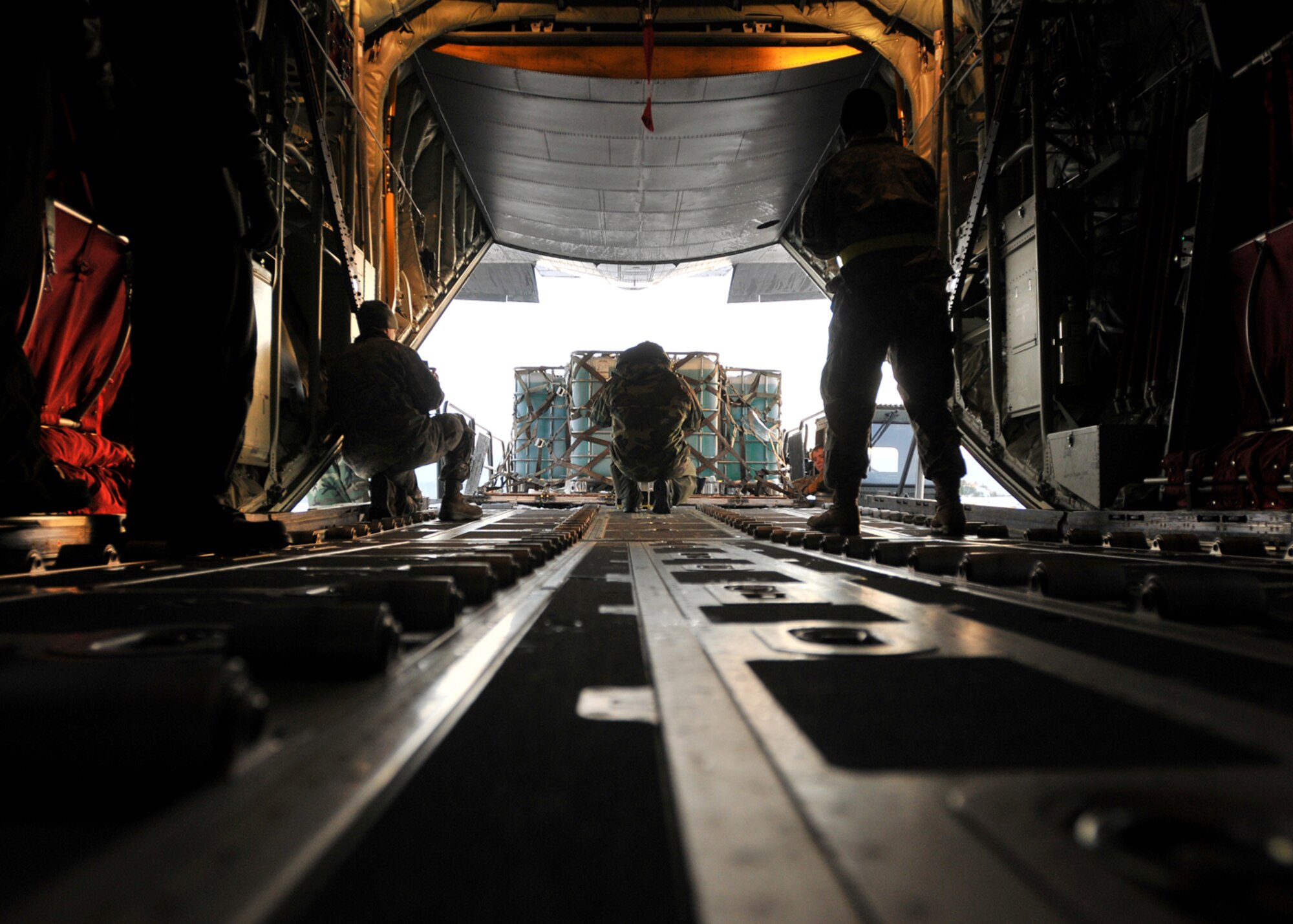 Air Force personnel load fire retardant onto a C-130-J Super Hercules, bound for Israel, at Ramstein Air Base, Germany, Dec. 4.  The fire retardant is part of a joint U.S. Air Forces and U.S. European Command effort to assist the Israeli government in fighting wild fires in their country. (U.S. Air Force photo by Tech. Sgt. Markus M. Maier)