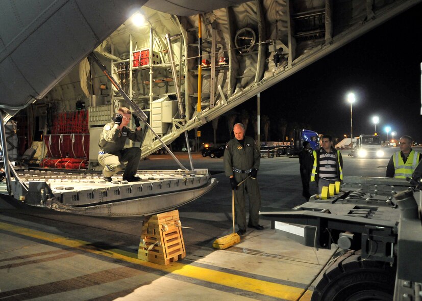 U.S. Airmen unload fire retardant from a C-130-J Super Hercules at the Ben Gurion International Airport, , Israel, Dec. 4.  The fire retardant is part of a joint U.S. Air Forces and U.S. European Command effort to assist the Israeli government in fighting wild fires in their country. (U.S. Air Force photo by Tech. Sgt. Markus M. Maier)
