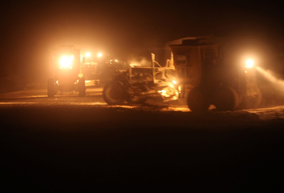 Heavy equipment operators with Heavy Equipment Platoon, Service Company, 8th Engineer Support Battalion, 1st Marine Logistics Group (Forward), grade the road while improving Route 611 in Sangin, Afghanistan, Dec. 5. Marines with 8th ESB conducted road-improvement operations in order to provide a safer route for local Afghans and coalition forces in the area.