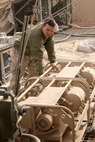 Lance Cpl. Andrew C. Grencer, a water purification technician with Utilities Platoon, Service Company, 8th Engineer Support Battalion, 1st Marine Logistics Group (Forward), turns on a water pump at Forward Operating Base Nolay in Helmand province, Afghanistan, Dec. 5. Water purification technicians with 8th ESB provide laundry and shower services for Marines with 3rd Battalion, 5th Marine Regiment, 1st Marine Division (Forward), who operate from the FOB.