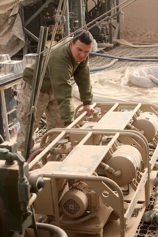 Lance Cpl. Andrew C. Grencer, a water purification technician with Utilities Platoon, Service Company, 8th Engineer Support Battalion, 1st Marine Logistics Group (Forward), turns on a water pump at Forward Operating Base Nolay in Helmand province, Afghanistan, Dec. 5. Water purification technicians with 8th ESB provide laundry and shower services for Marines with 3rd Battalion, 5th Marine Regiment, 1st Marine Division (Forward), who operate from the FOB.
