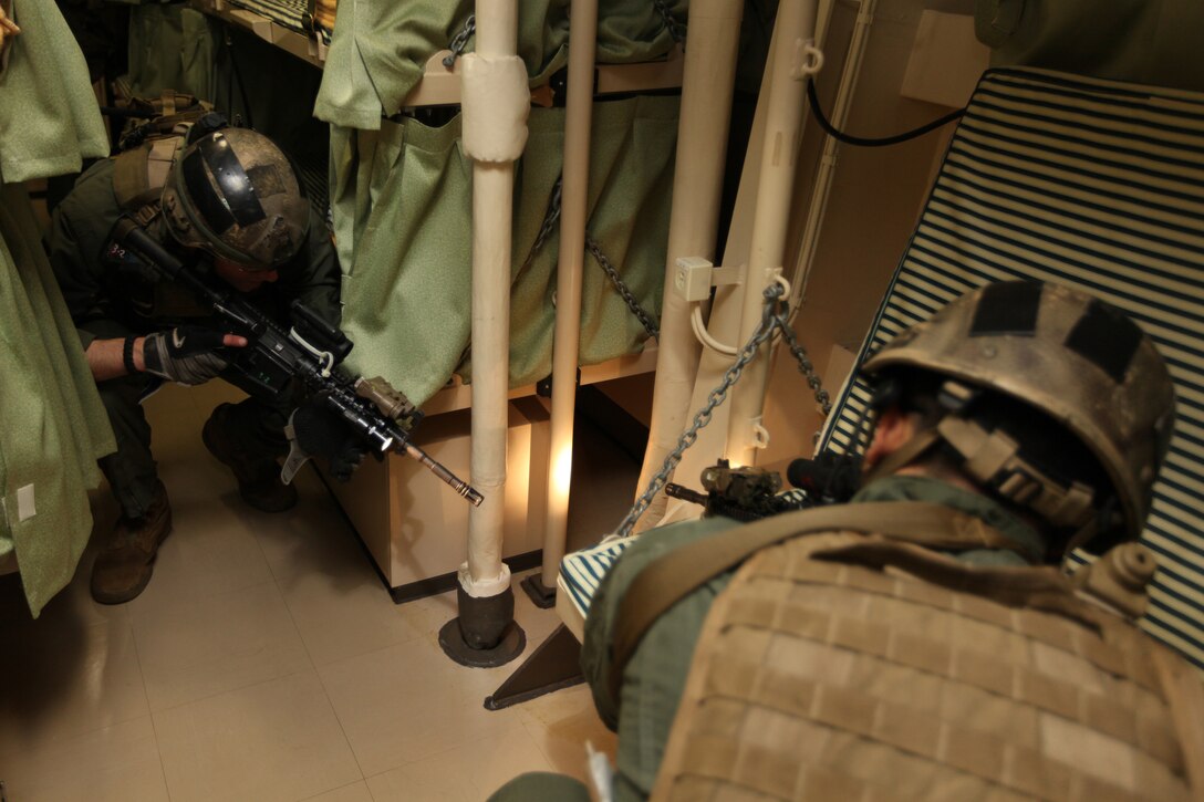 U.S. Marines with Force Reconnaissance Platoon, 31st Marine Expeditionary Unit, search a cargo area of the Japan Maritime Self-Defense Force ship J.F. Kunisaki during a Visit, Board, Search, and Seizure exercise in support of Keen Sword 2010.