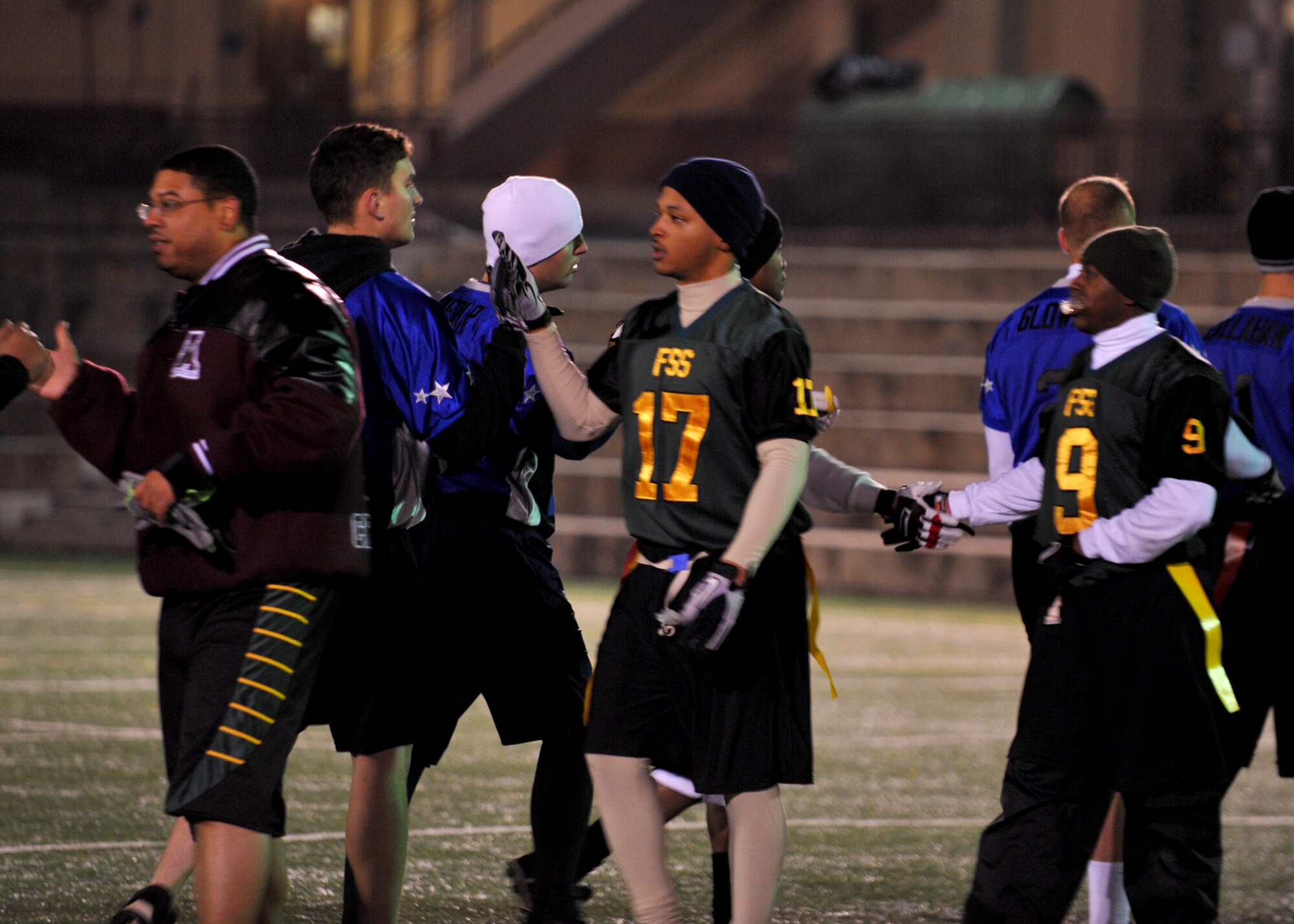 51st Force Support Squadron football players shake hands with 51st Aircraft Maintenance Squadron players after the base football intramurals championship Dec. 6 at Osan Air Base, Republic of Korea. The 51st Force Support Squadron took home the trophy with a winning score of 26-14. (U.S. Air Force photo/Senior Airman Evelyn Chavez)