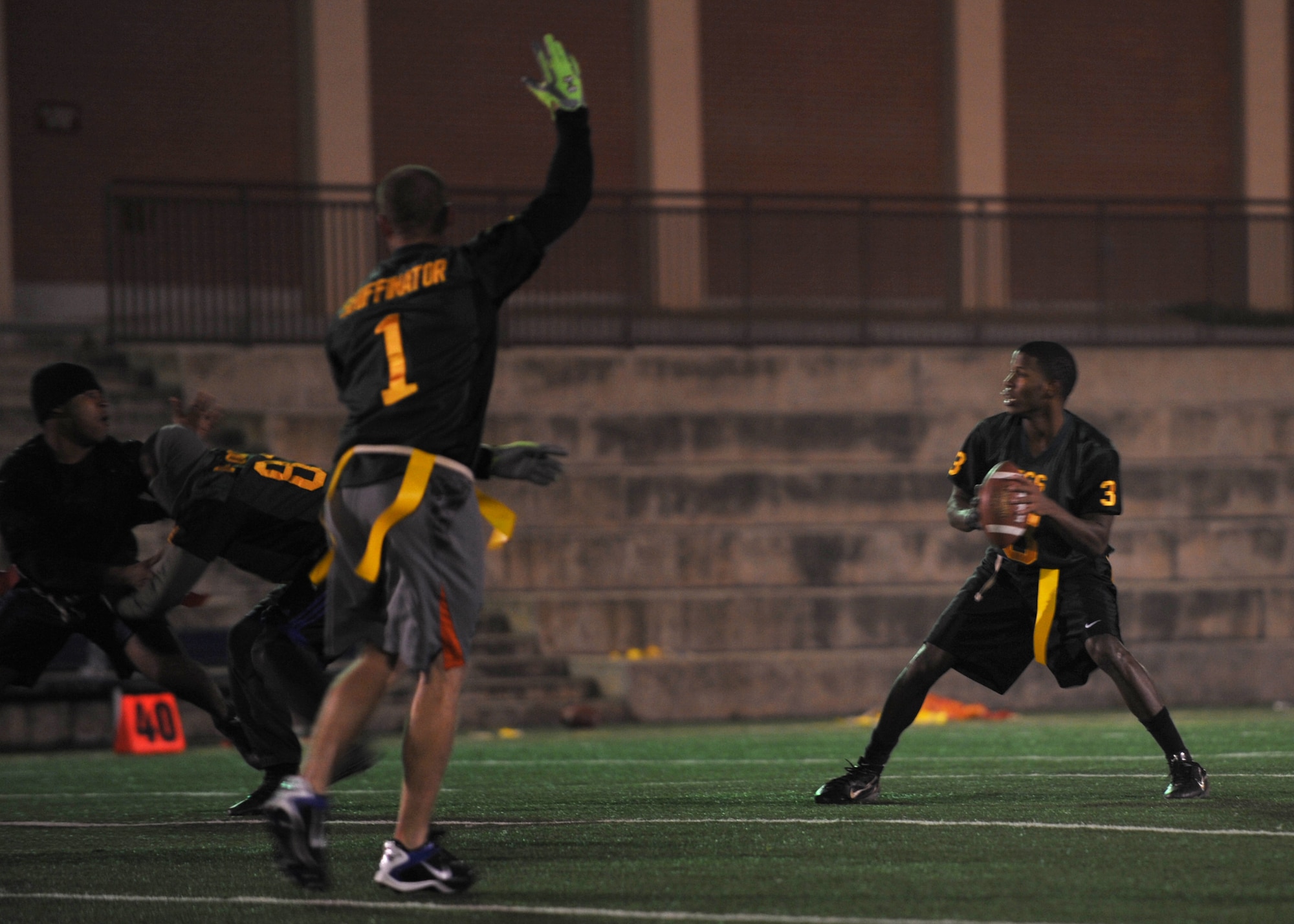 Jamaal Avington, 51st Force Support Squadron, prepares to throw a pass during the flag football intramural championship Dec. 6 at Osan Air Base, Republic of Korea. The 51st FSS team took home the trophy with a winning score of 26-14 against the 51st Aircraft Maintenance Squadron. (U.S. Air Force photo/Senior Airman Evelyn Chavez)