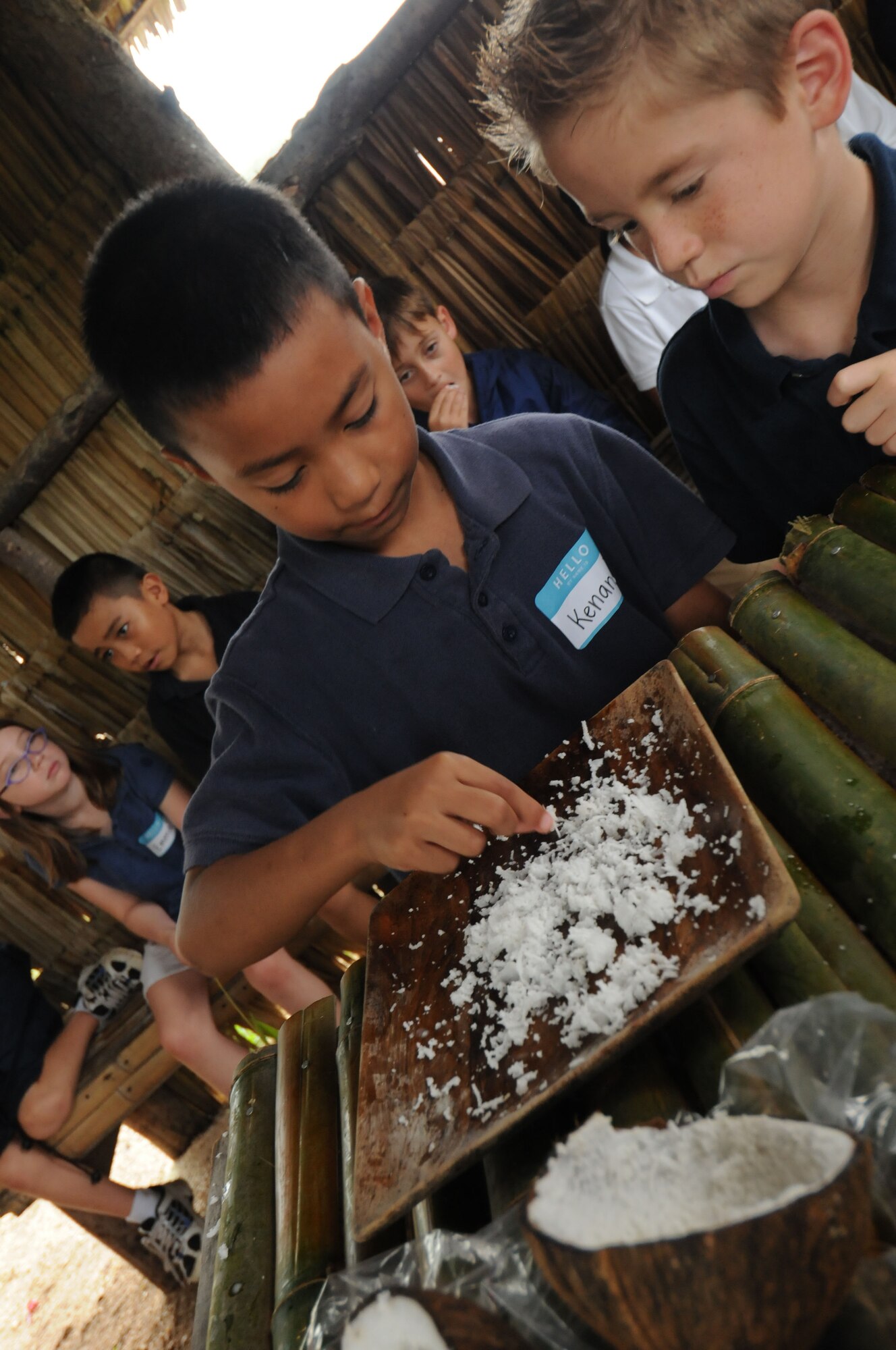 Students take their turn at tasting fresh coconut at Gef Pa’go Chamorro Cultural Village in Inarajan Bay. The students, 2nd graders from Andersen Elementary School, visited the village on a recent field trip to learn about the Chamorro culture. (U.S. Air Force photo/Master Sgt. Carrie Hinson)