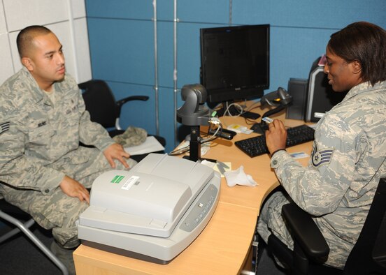 KUNSAN AIR BASE, Republic of Korea -- Staff Sgt. Keneshia Sherman, 8th Force Support Squadron customer support supervisor, takes information from Staff Sgt. Jesus Munoz, 8th Medical Support Squadron, for issuance of a new common access card here Dec. 6, 2010. Some of the responsibilities of the military personnel element are assignment processing, awards and decorations, and in and out-processing of base personnel. (U.S. Air Force photo/Senior Airman Ciara Wymbs
