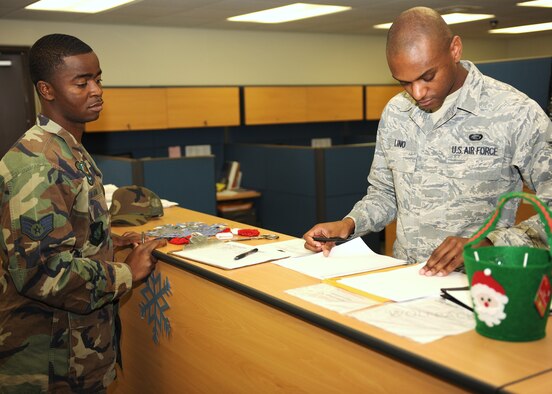 KUNSAN AIR BASE, Republic of Korea -- Senior Airman D'Angelo Lino, 8th Force Support Squadron customer support, inprocesses Staff Sgt. Kayode Salami, 8th Aircraft Maintenance Squadron material management to the base Dec. 6, 2010. All incoming personnel must inprocess with the 8th FSS customer support element within the first week of arrival to Kunsan. (U.S. Air Force photo/Senior Airman Ciara Wymbs)
