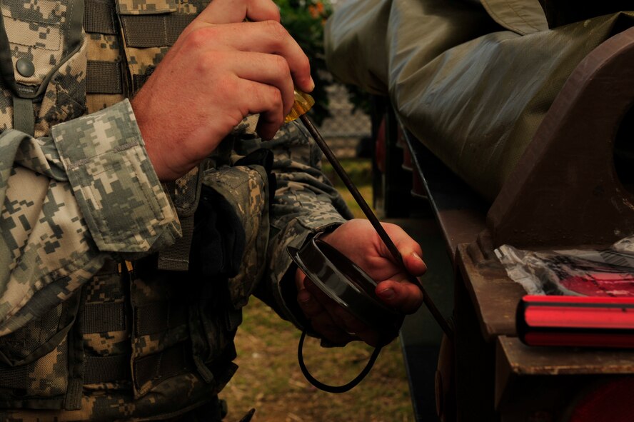 Pvt. Matthew Jacewicz, a command control technician with the U.S. Army, performs maintenance on a picture system radar during Keen Sword 2011 at Camp Courtney, Dec. 4. Keen Sword is a regularly scheduled exercise that strengthens Japan-U.S. military interoperability and meets mutual defense objectives. Japan-U.S. military operations and exercises increase readiness to respond to varied crisis situations. (U.S. Air Force photo/ Staff Sgt. Lakisha A. Croley) 