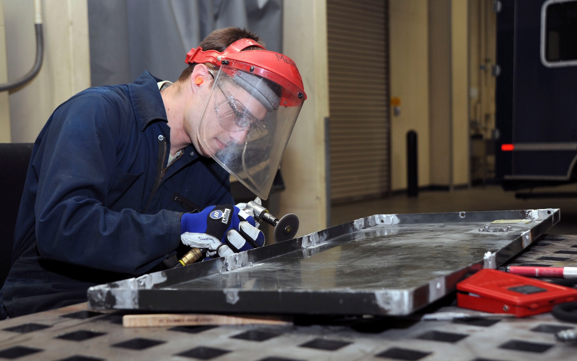 U.S. Airman 1st Class Travis Long, 35th Maintenance Squadron, Aircraft Structural Maintenance, grinds on a piece equipment at Misawa Air Base, Japan, Nov. 15, 2010. Airman Long works in the Aircraft Metals Technology flight, one of three elements of the fabrication flight. (U.S. Air Force photo by Tech. Sgt. Russell McBride/Released)

