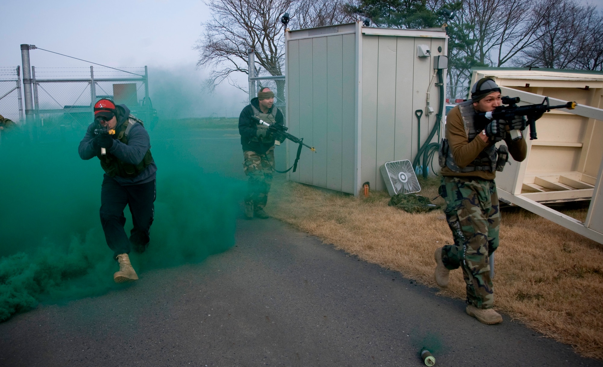 Staff Sgt. Martin Campos, Tech. Sgt. George Shepherd and Airman 1st Class Candido Berio-Figueroa , 35th Security Forces Squadron and opposing forces members, charge the Apple gate Dec. 5, 2010, during a bilateral exercise at Misawa Air Base, Japan. The exercise brought together members of the Japan Ground Self-Defense Force, Japan Air Self Defense Force, and the U.S. Air Force to practice defending the base against potential threats such as unauthorized entries, improvised explosive devices, surveillance and probing by adversaries. (U.S. Air Force photo by Senior Airman Jessica Lockoski/Released)