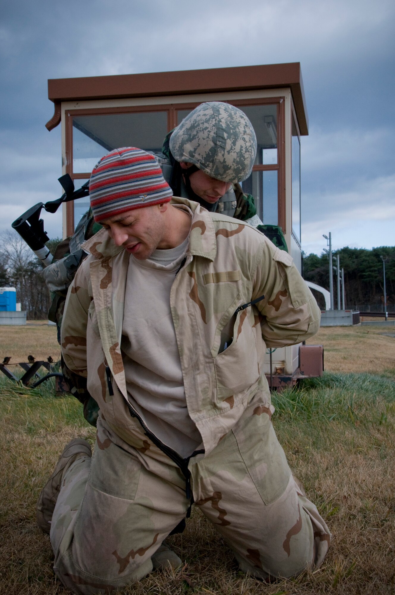 Senior Airman Kevin Gonzales, 35th Security Forces Squadron patrolman searches Senior Airman William Holliday, 35th Explosive Ordnance Disposal and opposing forces member, Dec. 4, 2010, during a bilateral guard and protect exercise at Misawa Air Base, Japan.  Opposing forces simulated hostile enemy actions against Japan Ground Self Defense Force and Air Self Defense Force and the 35th SFS during the exercise to test the combined force’s ability to protect Misawa’s war fighting assets.  (U.S. Air Force photo by Senior Airman Jessica Lockoski/Released) 
