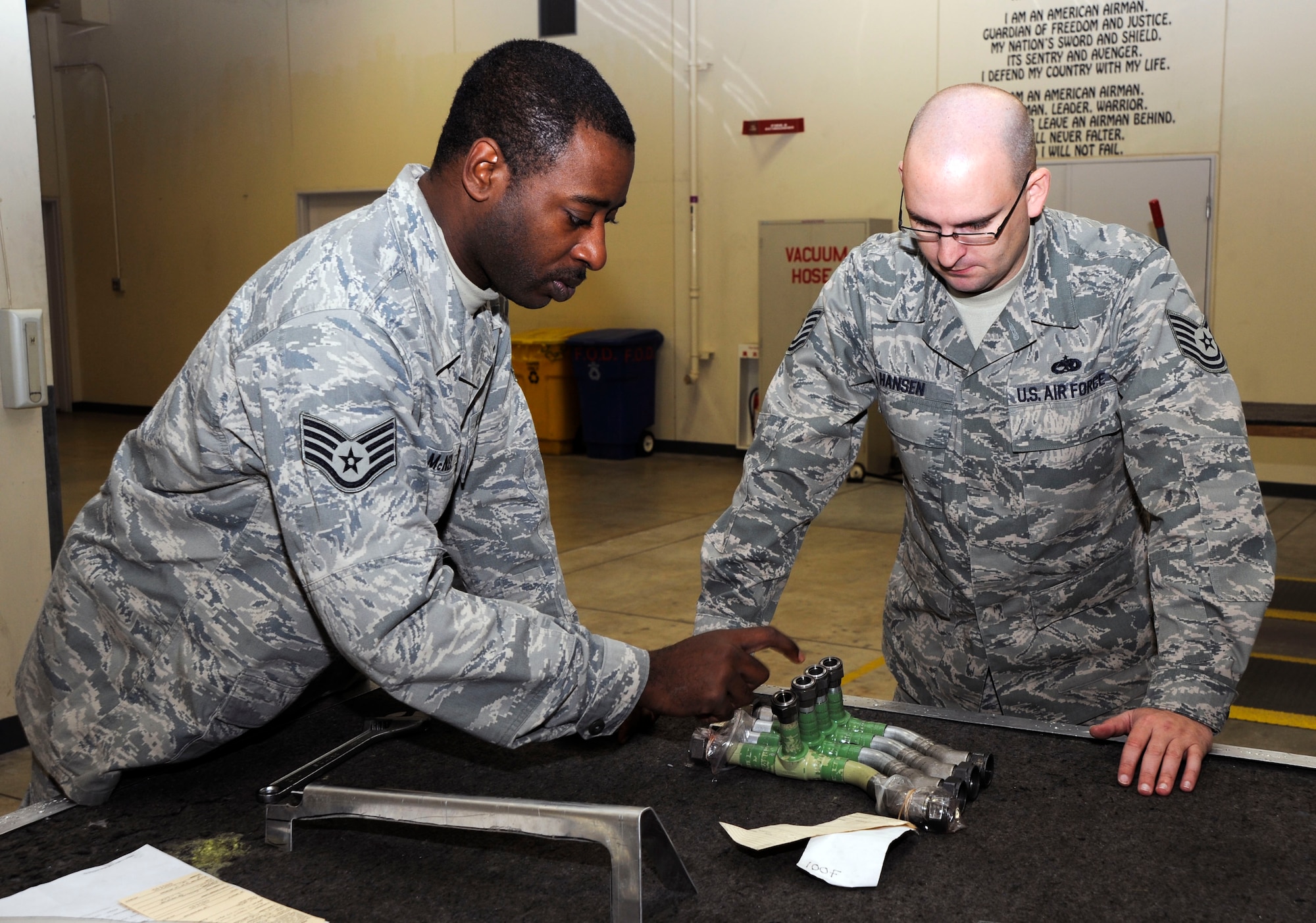 U.S. Air Force Staff Sgt.  Andre McNeil, left, and Tech. Sgt. Daniel Hansen both with 35th Maintenance Squadron, Aircraft Structural Maintenance  evaluate ?A?-System hydraulic lines at Misawa Air Base, Japan, Nov. 16, 2010. The parts they are inspecting are used on Misawa?s F-16 Fighting Falcons. (U.S. Air Force photo by Tech. Sgt. Russell McBride/Released)