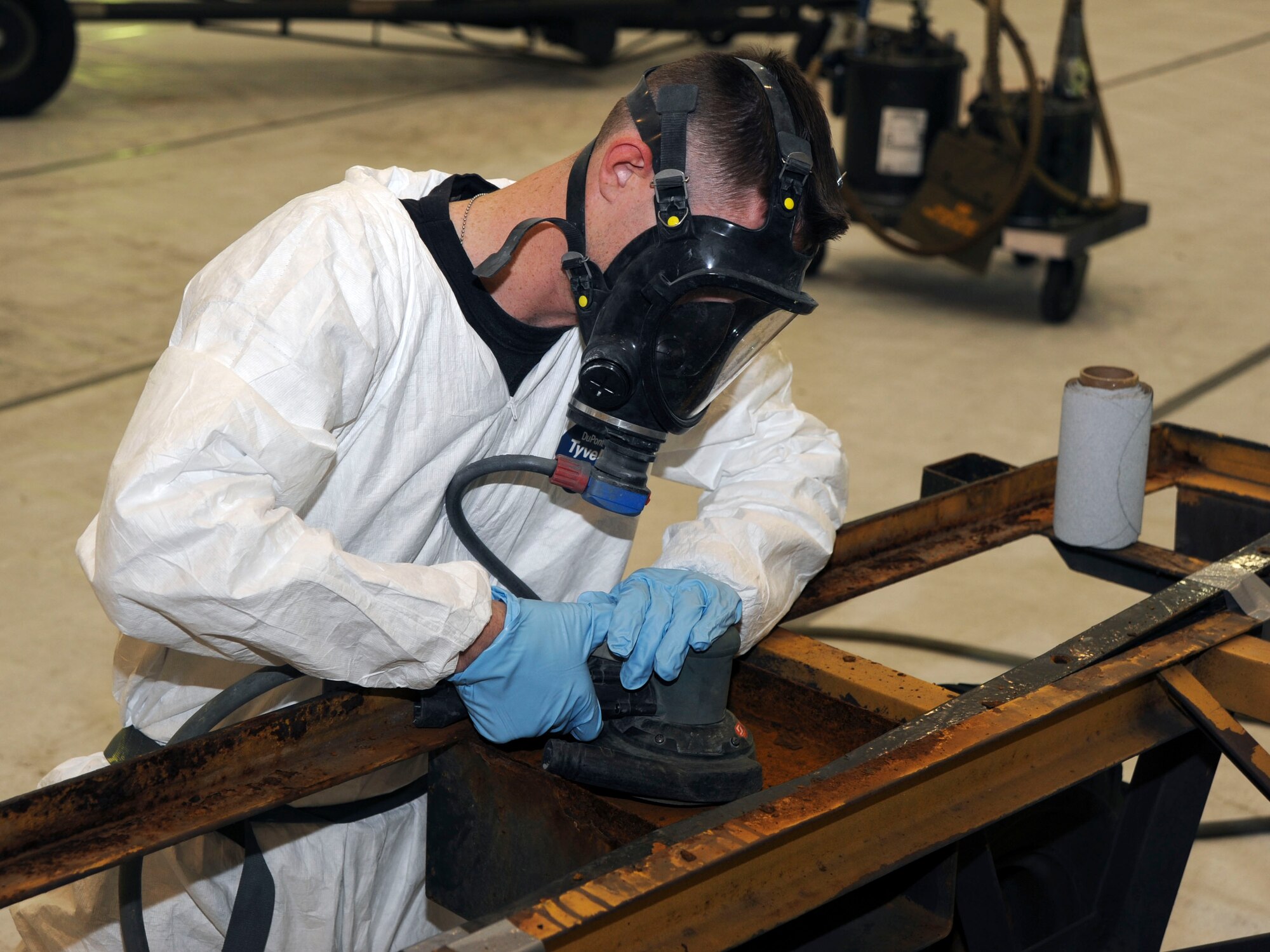 U.S. Air Force Senior Airman Ken Bearly, 35th Maintenance Squadron, Aircraft Structural Maintenance, Corrosion Control, removes corrosion and preps an armament trailer for paint at Misawa Air Base, Japan, Nov. 16, 2010. The 35th AMS is a component of the 35th Maintenance Group, 35th Fighter Wing. (U.S. Air Force photo by Tech. Sgt. Russell McBride/Released)