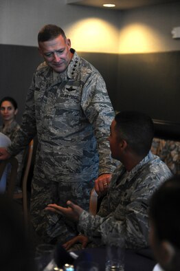 Gen. Gary North, Commander, Pacific Air Forces, speaks with Airman 1st Class Daniel Hernandez, 647th Civil Engineer Squadron utilities apprentice, during General North's visit to Joint Base Pearl Harbor-Hickam, Hawaii. During a luncheon with Airmen here, Airman Hernandez inquired about prospective international challenges the Air Force may face in the future. (U.S. Air Force photo/Airman 1st Class Lauren Main)