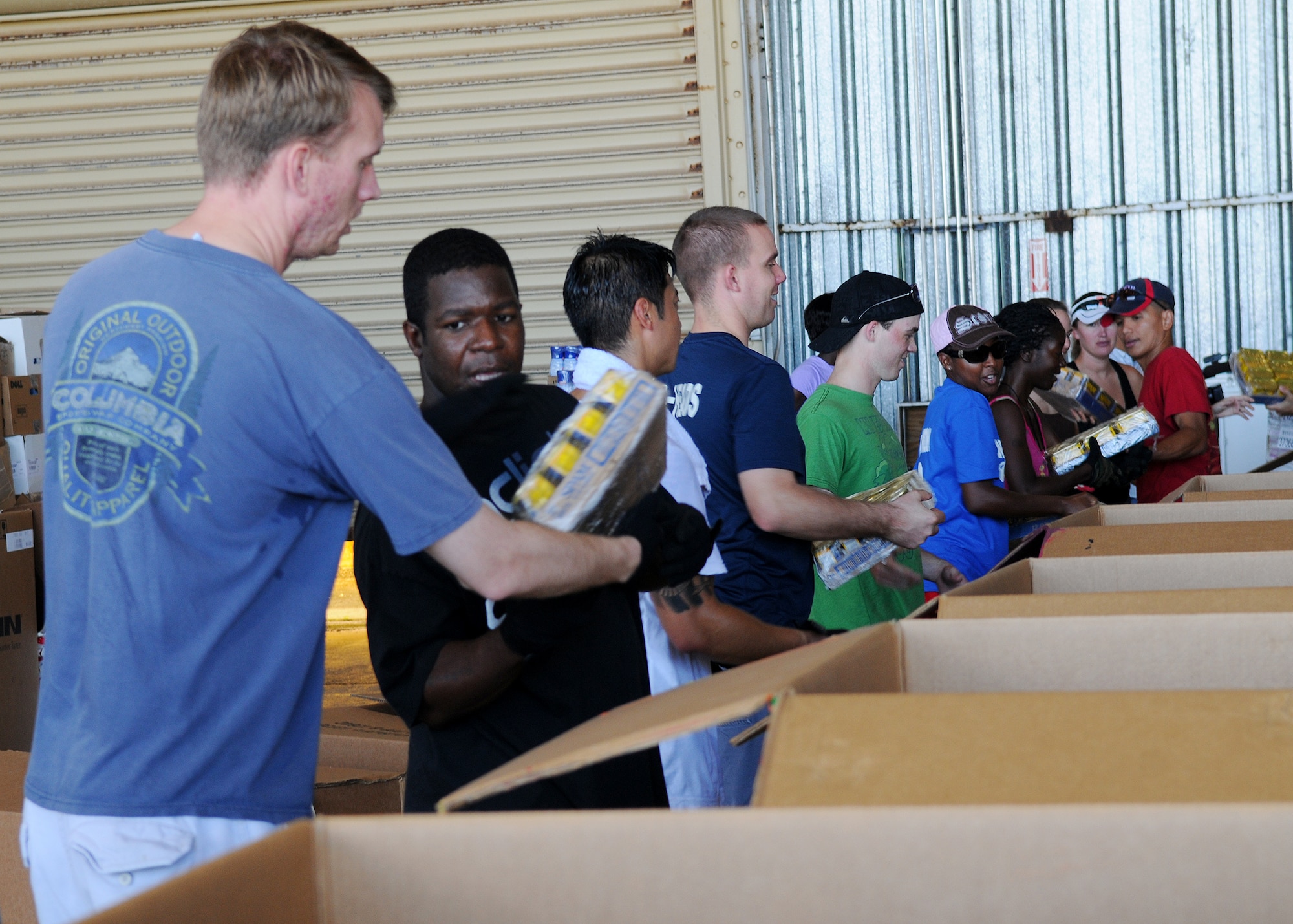 Team Andersen volunteers came out for the Operation Christmas drop box build in Hangar 5 at Andersen Air Force Base, Guam, Dec. 4, 2010. The volunteers made sure each box contained non-perishable food items, clothing, and much more. In all more than 57 boxes were built for the drop. Operation Christmas Drop is a non-profit organization powered by volunteers from Andersen AFB and the 36th Airlift Squadron from Yokota Air Base, Japan. Every year as part of a training exercise, the two join forces to drop supplies over the Micronesian Islands. (U.S. Air Force photo Senior Airman Nichelle Anderson)
