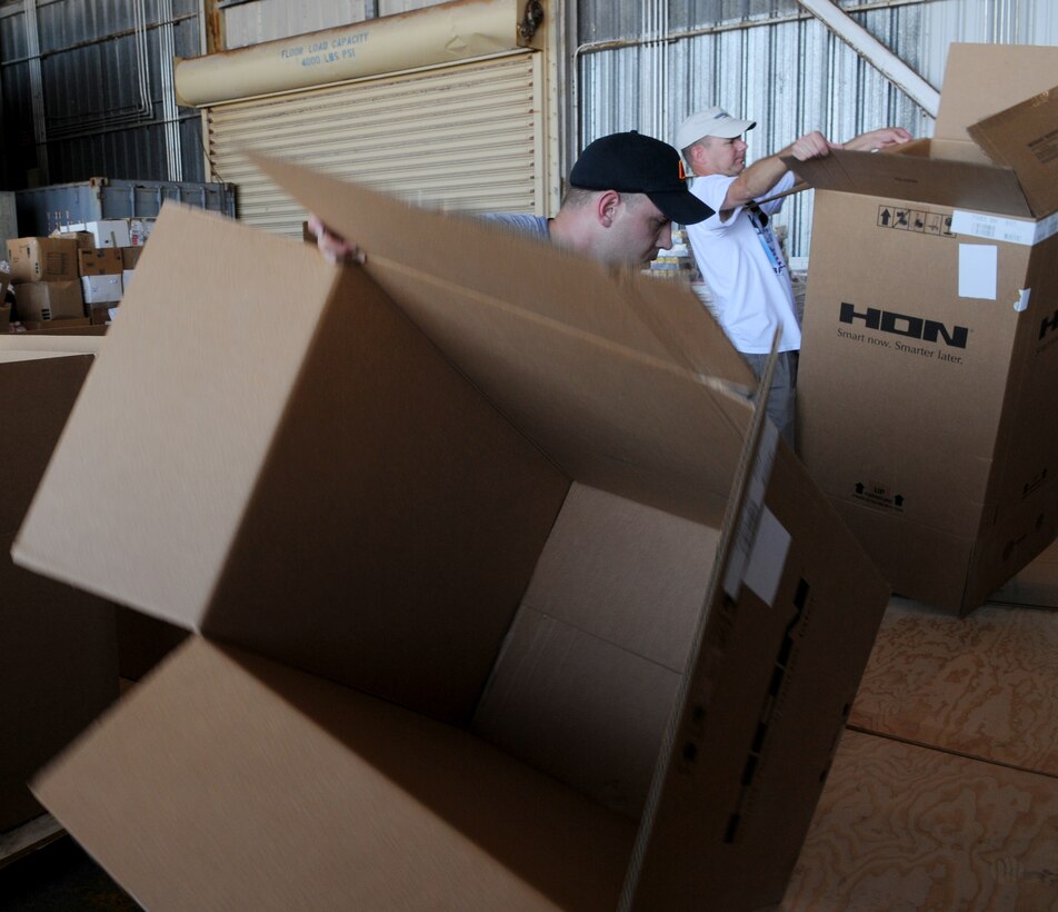 Team Andersen volunteers came out for the Operation Christmas drop box build in Hangar 5 at Andersen Air Force Base, Guam, Dec. 4, 2010. The volunteers made sure each box contained non-perishable food items, clothing, and much more. In all more than 57 boxes were built for the drop. Operation Christmas Drop is a non-profit organization powered by volunteers from Andersen AFB and the 36th Airlift Squadron from Yokota Air Base, Japan. Every year as part of a training exercise, the two join forces to drop supplies over the Micronesian Islands. (U.S. Air Force photo Senior Airman Nichelle Anderson)
