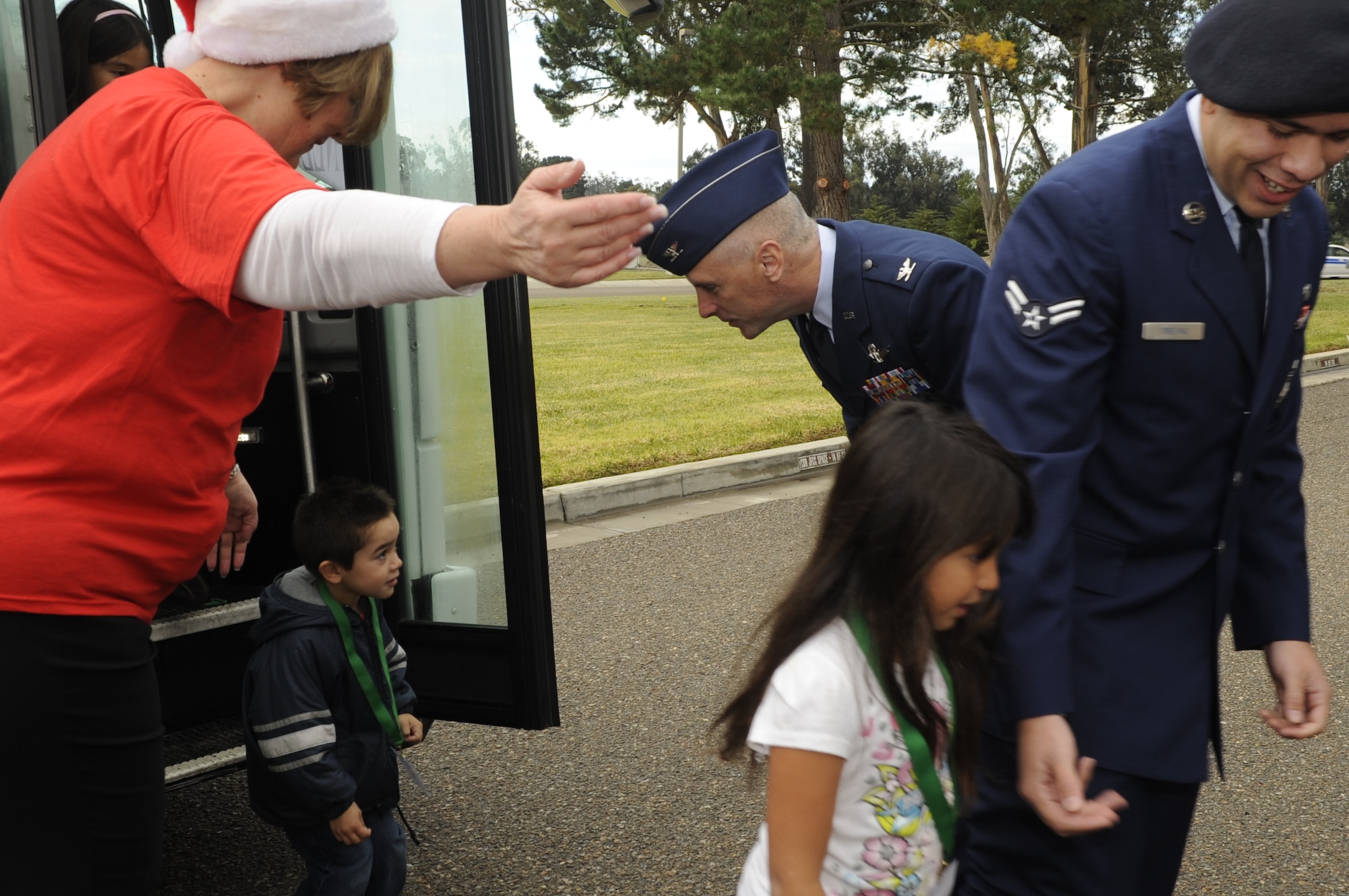 VANDENBERG AIR FORCE BASE, Calif. – Col. Richard Boltz, 30th Space Wing commander, greets children as they arrive at Vandenberg before they were paired up with an escort during the annual Operation Kids Christmas event here Saturday, Dec. 4, 2010. (U.S. Air Force photo/Airman 1st Class Lael Huss)
