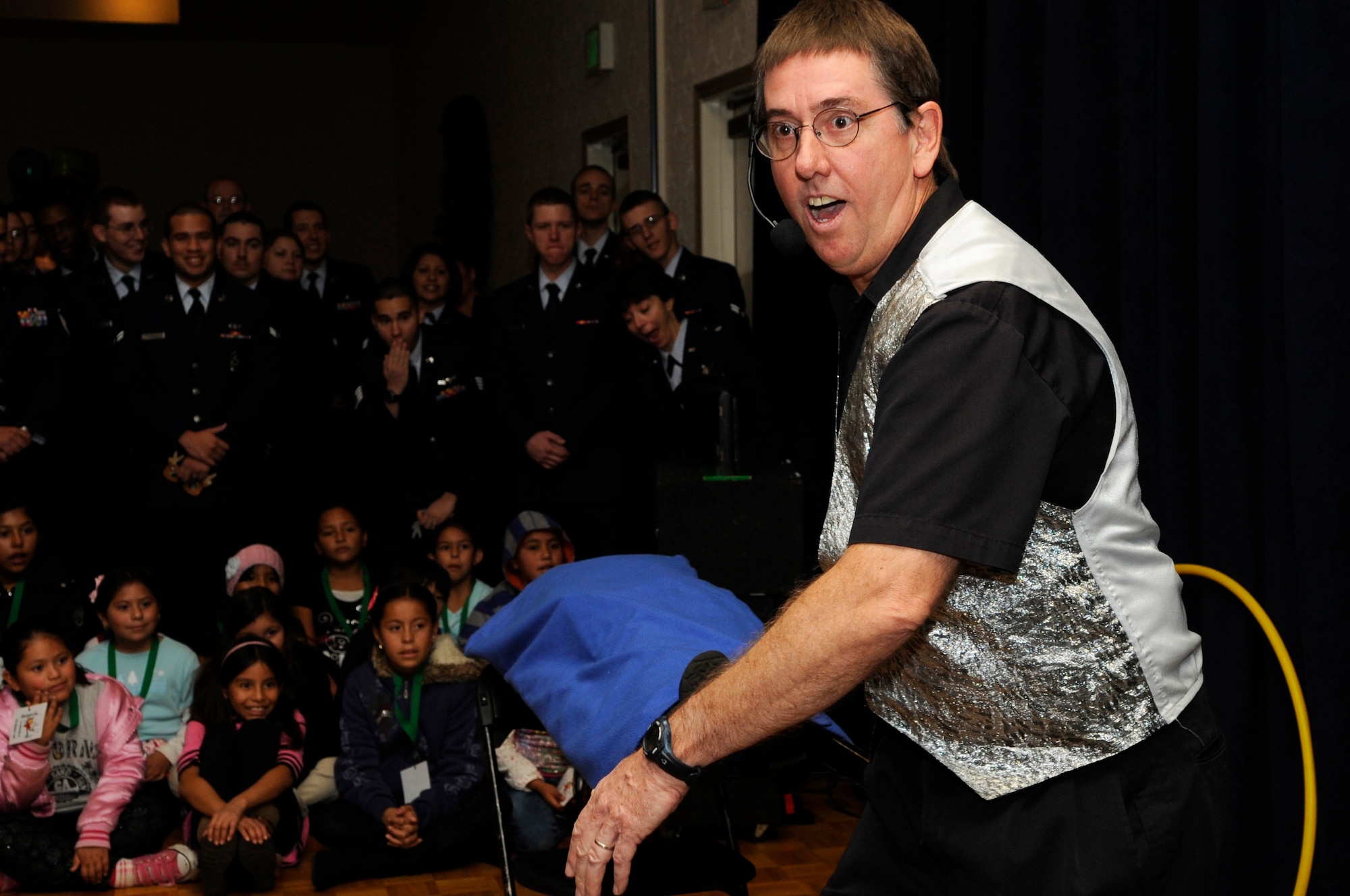 VANDENBERG AIR FORCE BASE, Calif. – Magician Jim Wilson and his assistant perform a levitation act during the Operation Kids Christmas event at the Pacific Coast Club here Saturday, Dec. 4, 2010. The holiday event offered various activities including a magician, balloon artist, an opera singer and a visit from Santa Claus. (U.S. Air Force photo/Airman 1st Class Lael Huss)