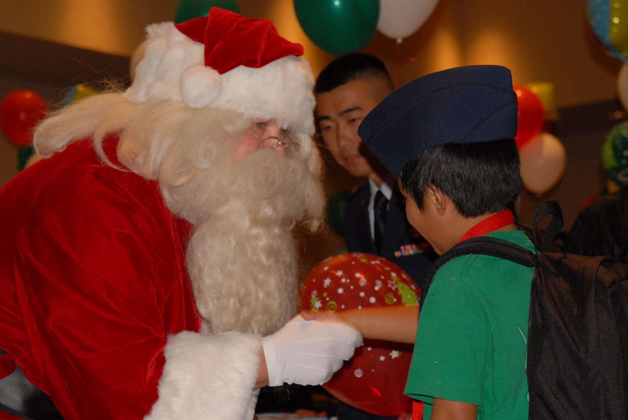 VANDENBERG AIR FORCE BASE, Calif. – A Santa Maria resident shakes Santa Claus’s hand at the Operation Kids Christmas event at the Pacific Coast Club here Saturday, Dec. 4, 2010. The holiday event offered various activities including a magician, balloon artist and an opera singer.  (U.S. Air Force photo/Jennifer Green)