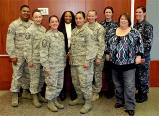 Tech. Sgt. John Hayes, Master Sgt. Lisamichelle Hughes-Belt, Master Sgt. Karen Cain, Peggy Moore-McCoy, Tech. Sgt. Annie Fernandez, Maj. Alisa Englert, Petty Officer 1st Class Amanda McNeely, Tammy Jordan, and Petty Officer 1st Class Erika Burrell, all of whom are victim advocates at Buckley Air Force Base, Colo., pose for a photo Nov 5, 2010. (U.S. Air Force photo/Airman 1st Class Paul Labbe) 