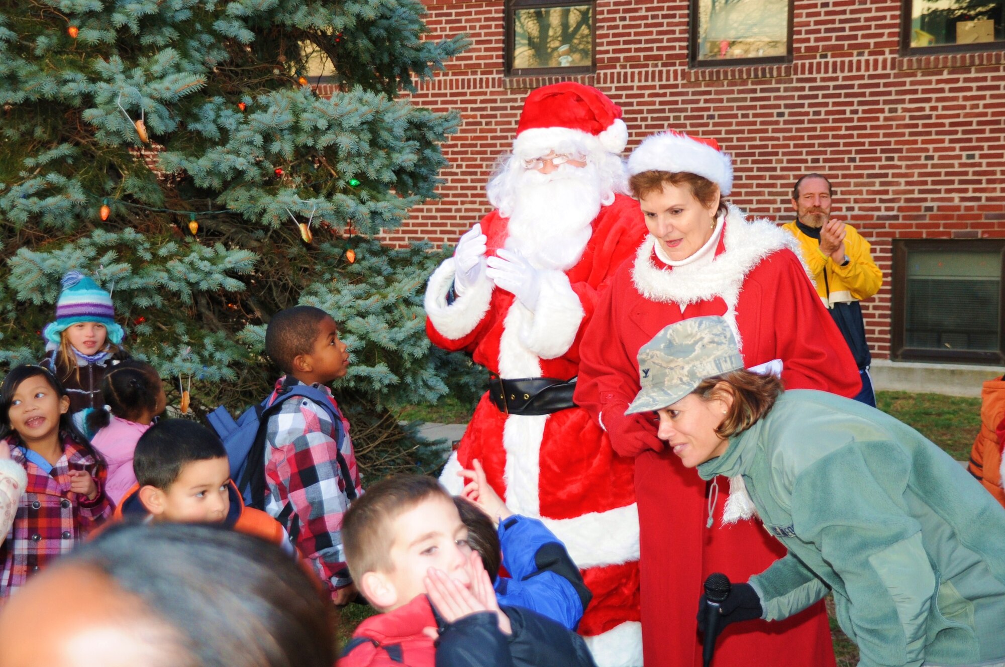 Joint Base McGuire-Dix-Lakehurst Commander Col. Gina Grosso converses with children during the Lakehurst tree lighting ceremony in front of Bldg. 150, Dec. 2. This was the first of two base tree lighting ceremonies that featured a visit from Santa and Mrs. Claus, as well as provided cookies and hot chocolate to get everyone in the holiday spirit. (U.S. Air Force photo/Airman 1st Class Dennis Sloan)