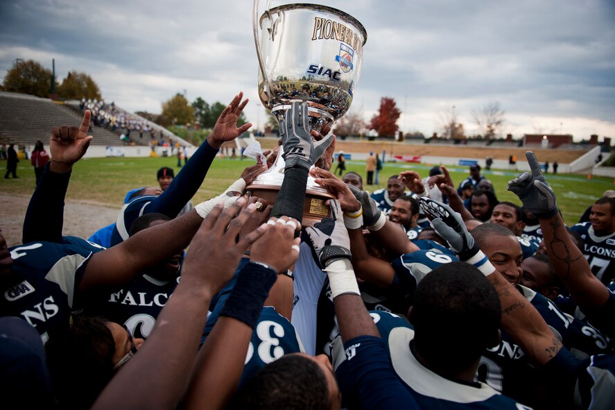 COLUMBUS, Ga. -- The St. Augustine's College Falcons raise the 2010 Pioneer Bowl trophy after their 20-9 victory over the Fort Valley State University Wildcats Dec. 4 at the A.J. McClung Memorial Stadium. The win marked the team's first bowl victory and the first Pioneer Bowl victory from a Central Intercollegiate Athletic Association team since 2004. The bowl game also marked the U.S. Air Force's first major sponsorship with historically black colleges and universities. (U.S. Air Force photo/Senior Airman Jamal D. Sutter)