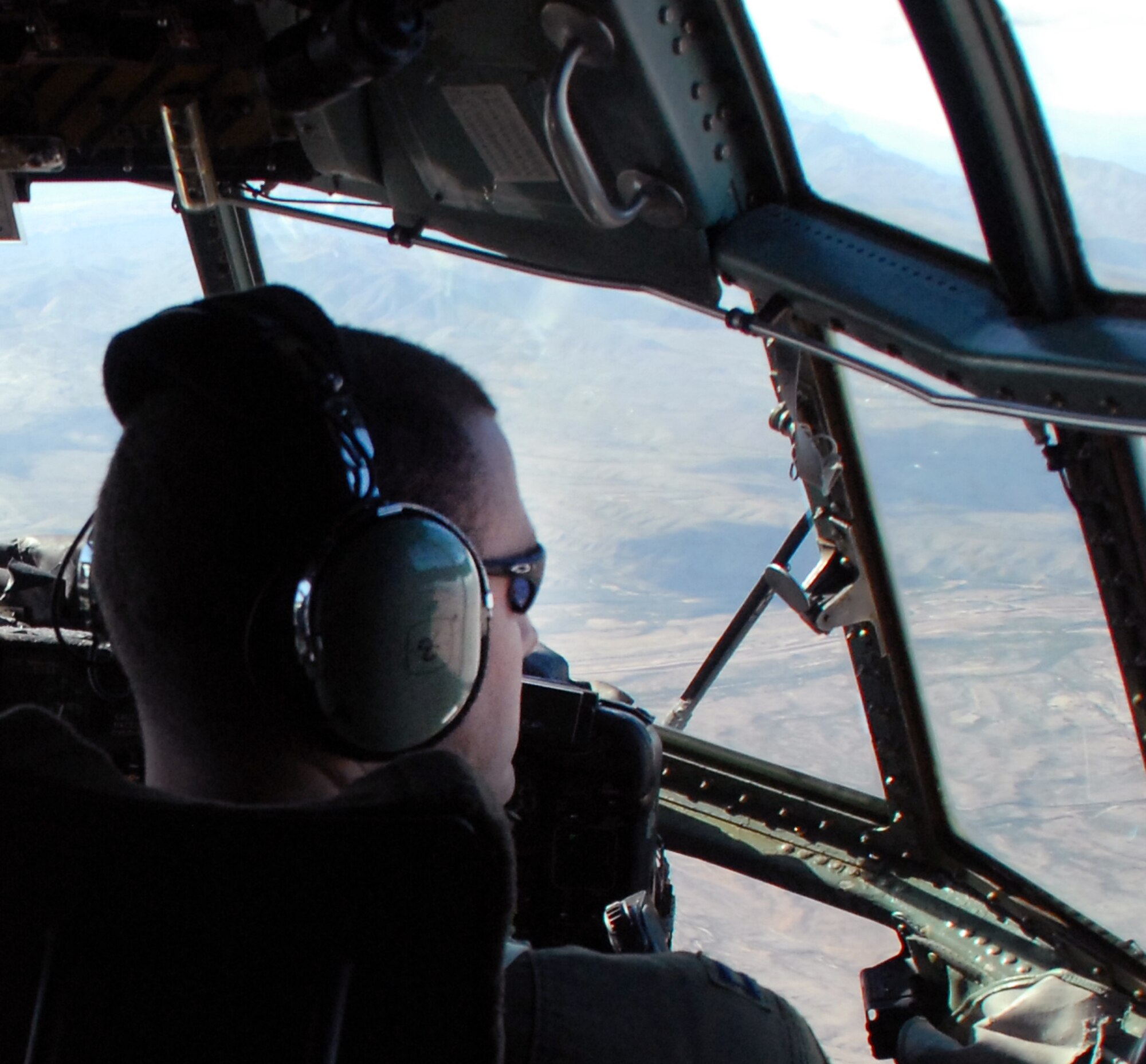 Capt. Greg Steenberge, 314th Airlift Wing assistant executive officer and the flight's copilot flies over mountainous terrain on the final flight of C-130E aircraft 62-1788, from Little Rock Air Force Base, Ark., to Davis-Monthan Air Force Base's 309th Aerospace Maintenance and Regeneration Group in Arizona Nov. 29, 2010.  The aircraft was retired as part of a strategic Air Force effort to modernize its C-130 fleet with C-130J and C-130H AMP aircraft to meet the needs of today's warfighters in a more efficient, cost-effective way. Captain Steenberge was the copilot for the flight. (U.S. Air Force photo by Capt. Joe Knable)