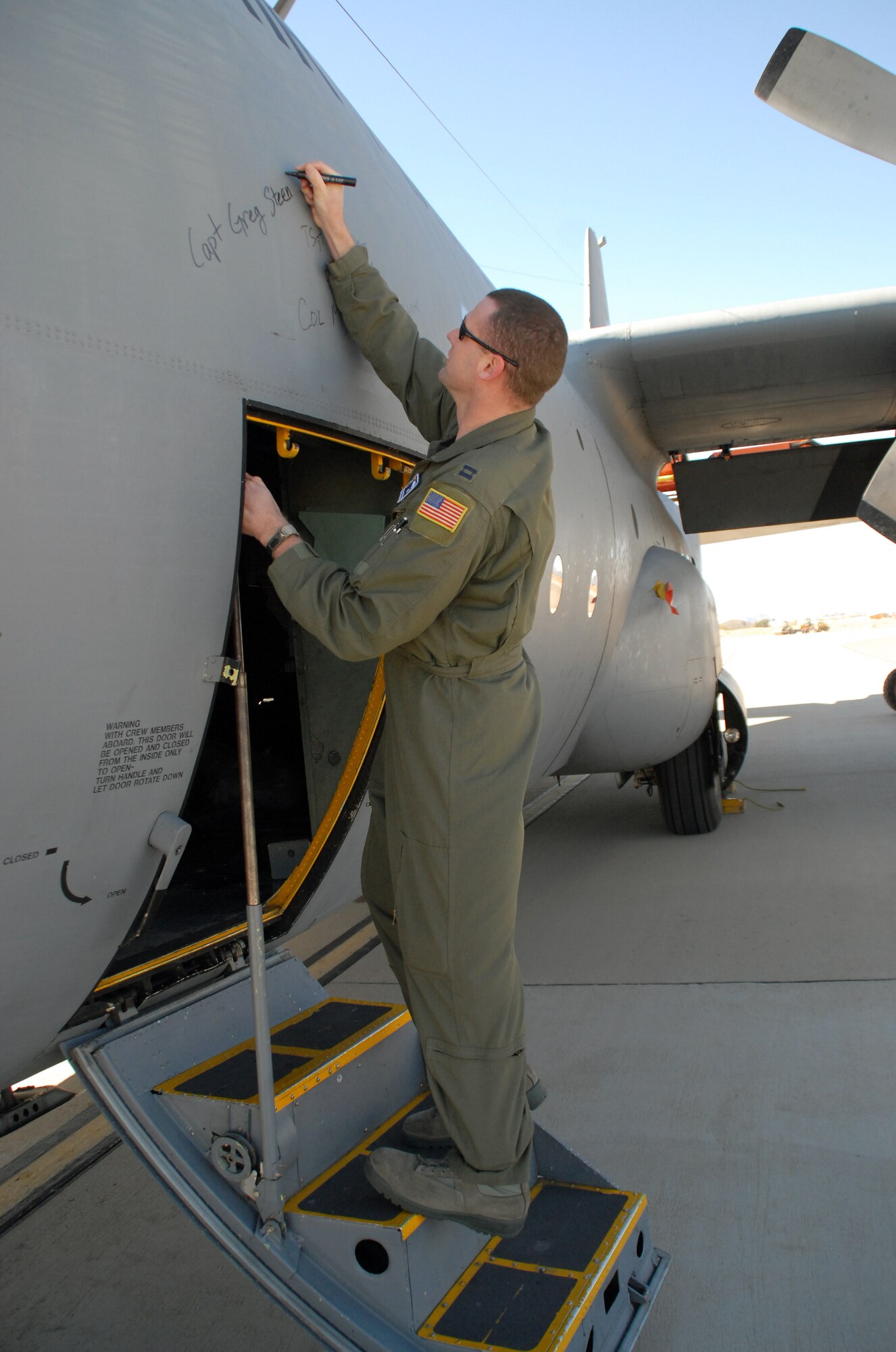 Capt. Greg Steenberge, 314th Airlift Wing assistant executive officer, signs his name on C-130E aircraft 62-1788 after it completed its final flight, to Davis-Monthan Air Force Base's 309th Aerospace Maintenance and Regeneration Group in Arizona Nov. 29, 2010. It is Air Force tradition for the crew who flies an aircraft's final flight to sign the aircraft after landing. Aircraft 62-1788 was retired as part of a strategic Air Force effort to modernize its C-130 fleet with C-130J and C-130H AMP aircraft to meet the needs of today's warfighters in a more efficient, cost-effective way. Captain Steenberge was the copilot for the flight. (U.S. Air Force photo by Capt. Joe Knable)