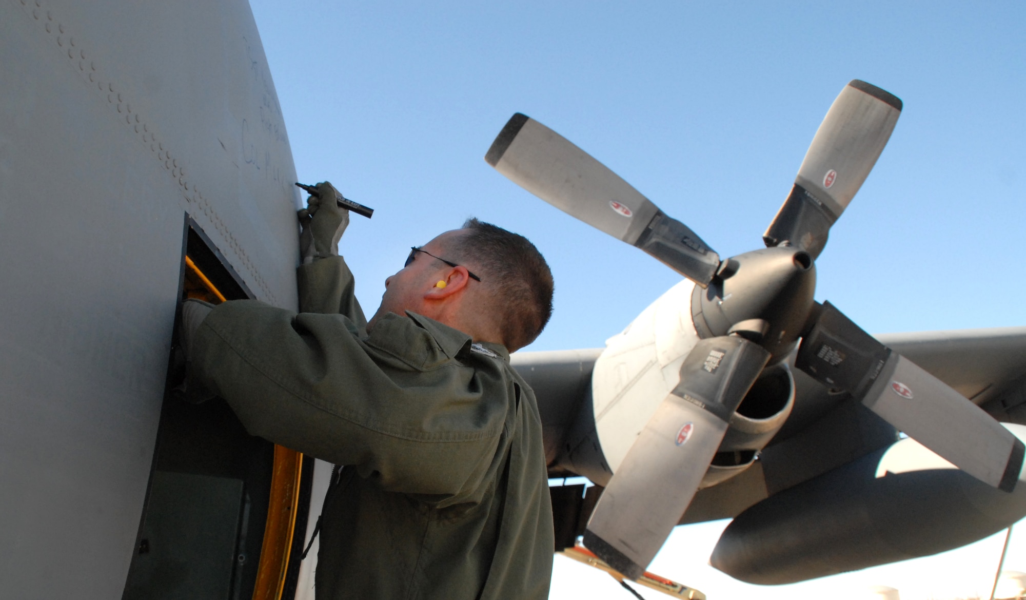 Col. Mark Czelusta, 314th Airlift Wing commander, signs his name on C-130E aircraft 62-1788 after it completed its final flight, to Davis-Monthan Air Force Base's 309th Aerospace Maintenance and Regeneration Group in Arizona Nov. 29, 2010. It’s Air Force tradition for the crew who flies an aircraft's final flight to sign the aircraft after landing. Aircraft 62-1788 was retired as part of a strategic Air Force effort to modernize its C-130 fleet with C-130J and C-130H AMP aircraft to meet the needs of today's warfighters in a more efficient, cost-effective way. Colonel Czelusta was the aircraft commander for the flight. (U.S. Air Force photo by Capt. Joe Knable)